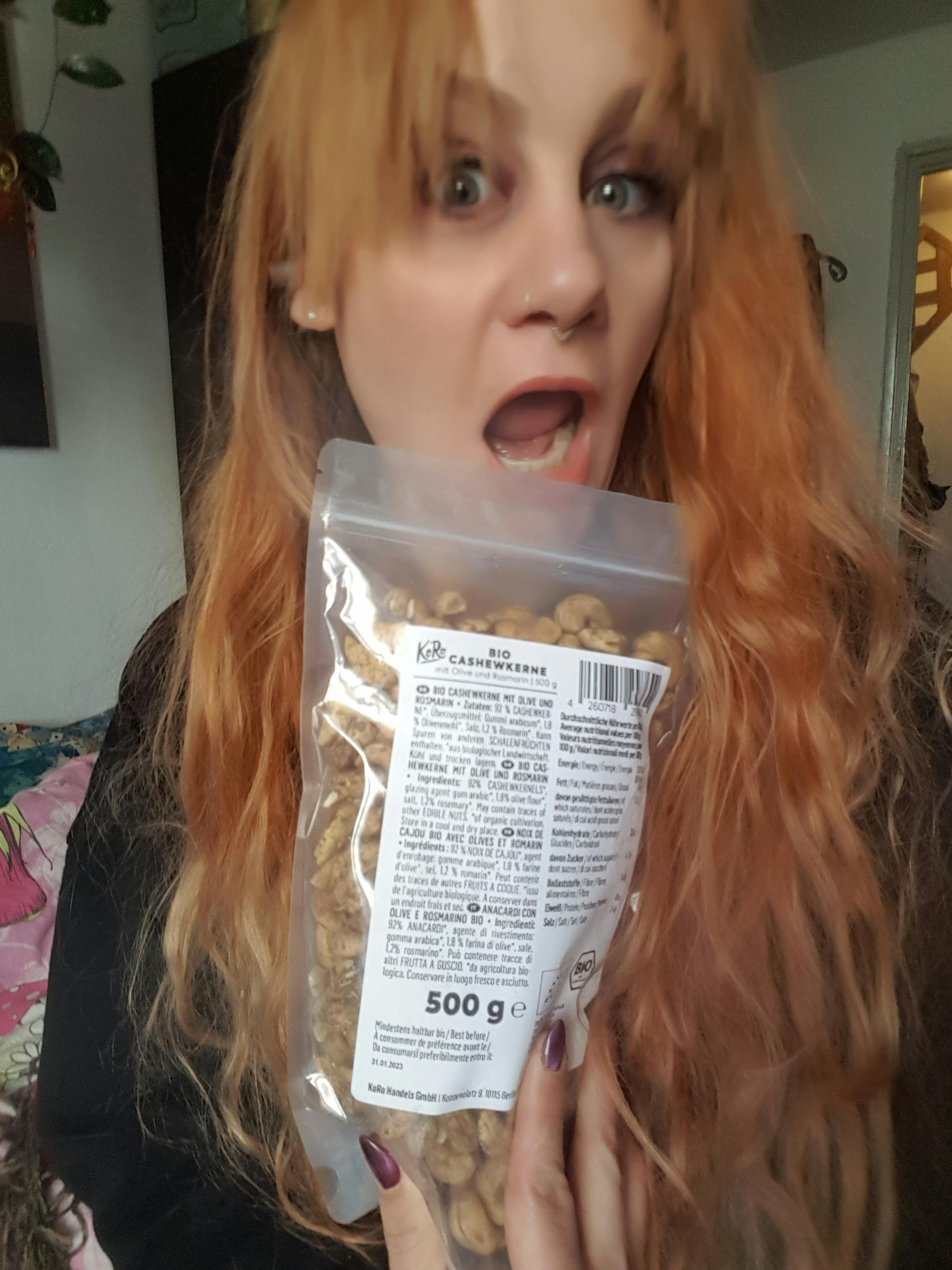 una donna con i capelli rossi tiene in mano una busta di noci