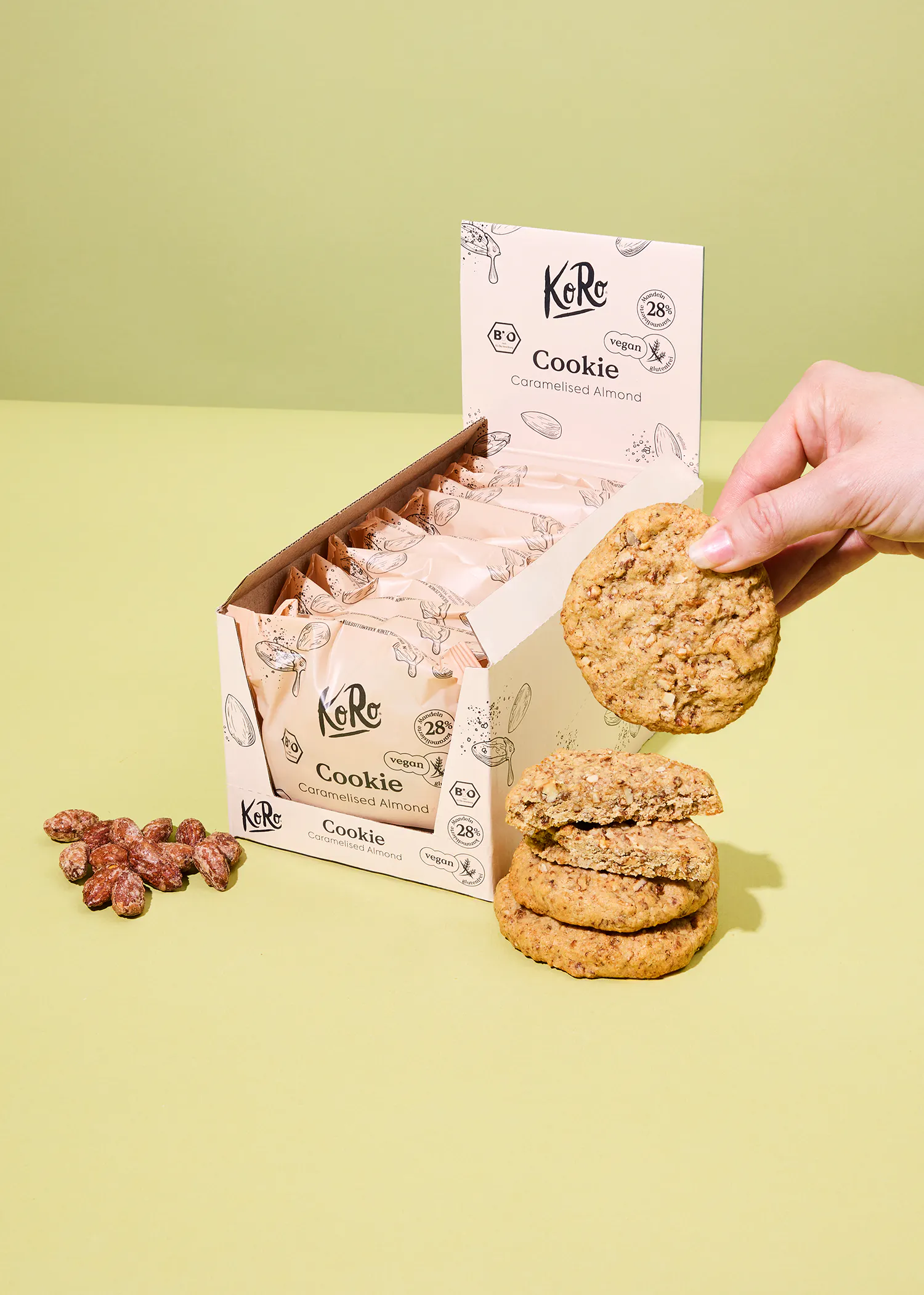 a person is holding a cookie next to a box of cookies