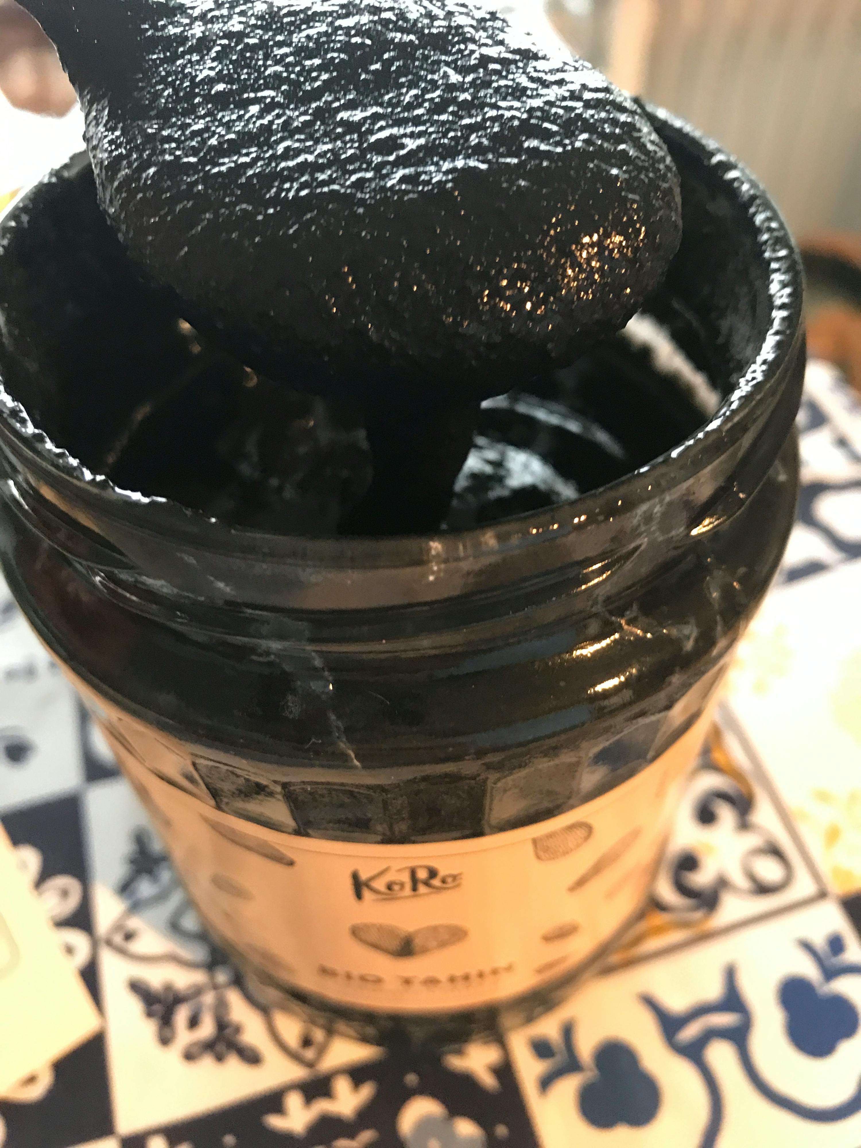 a close up of a black container with a label that says kara