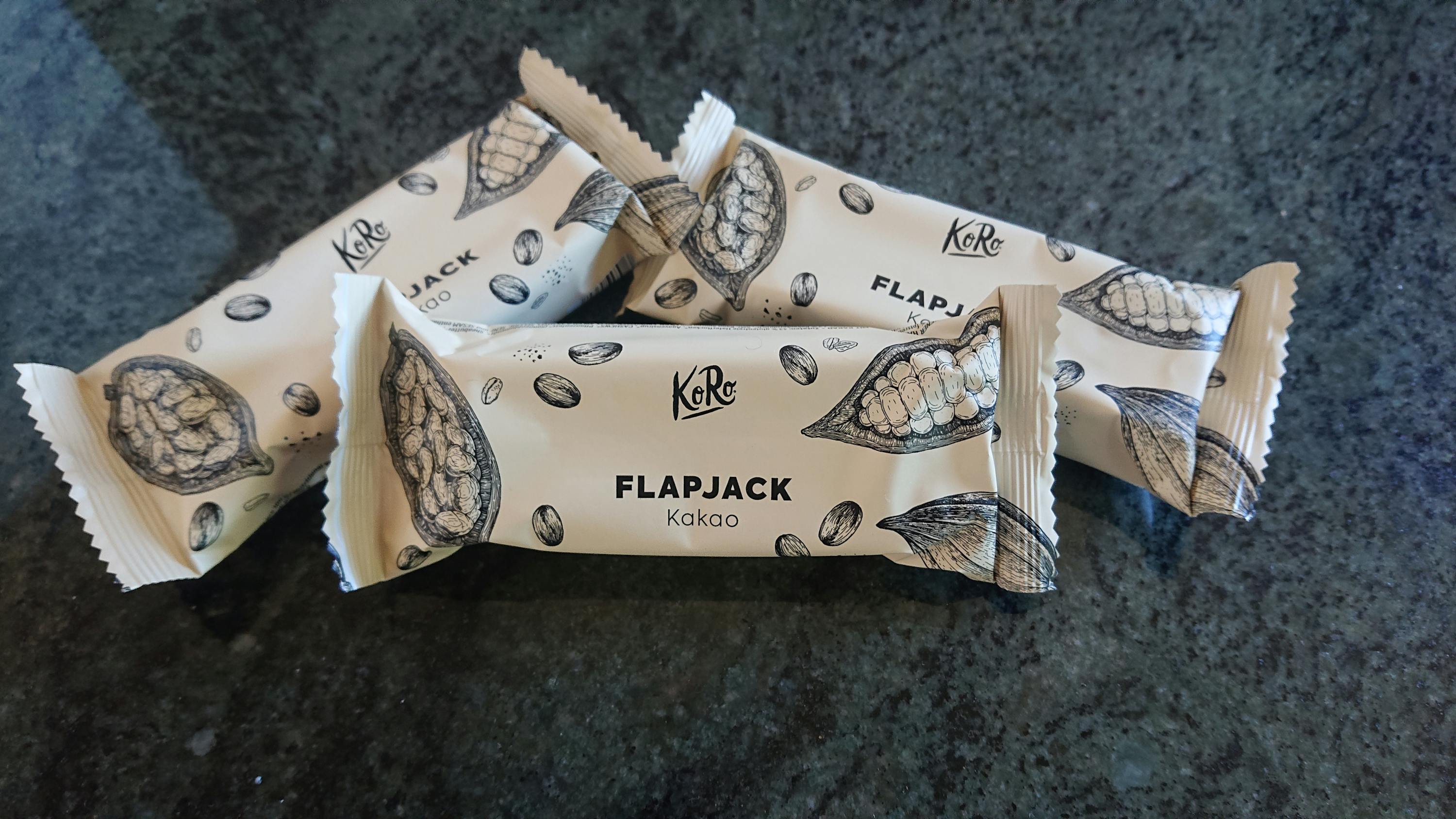 four wrappers of flapjack kakao are stacked on top of each other