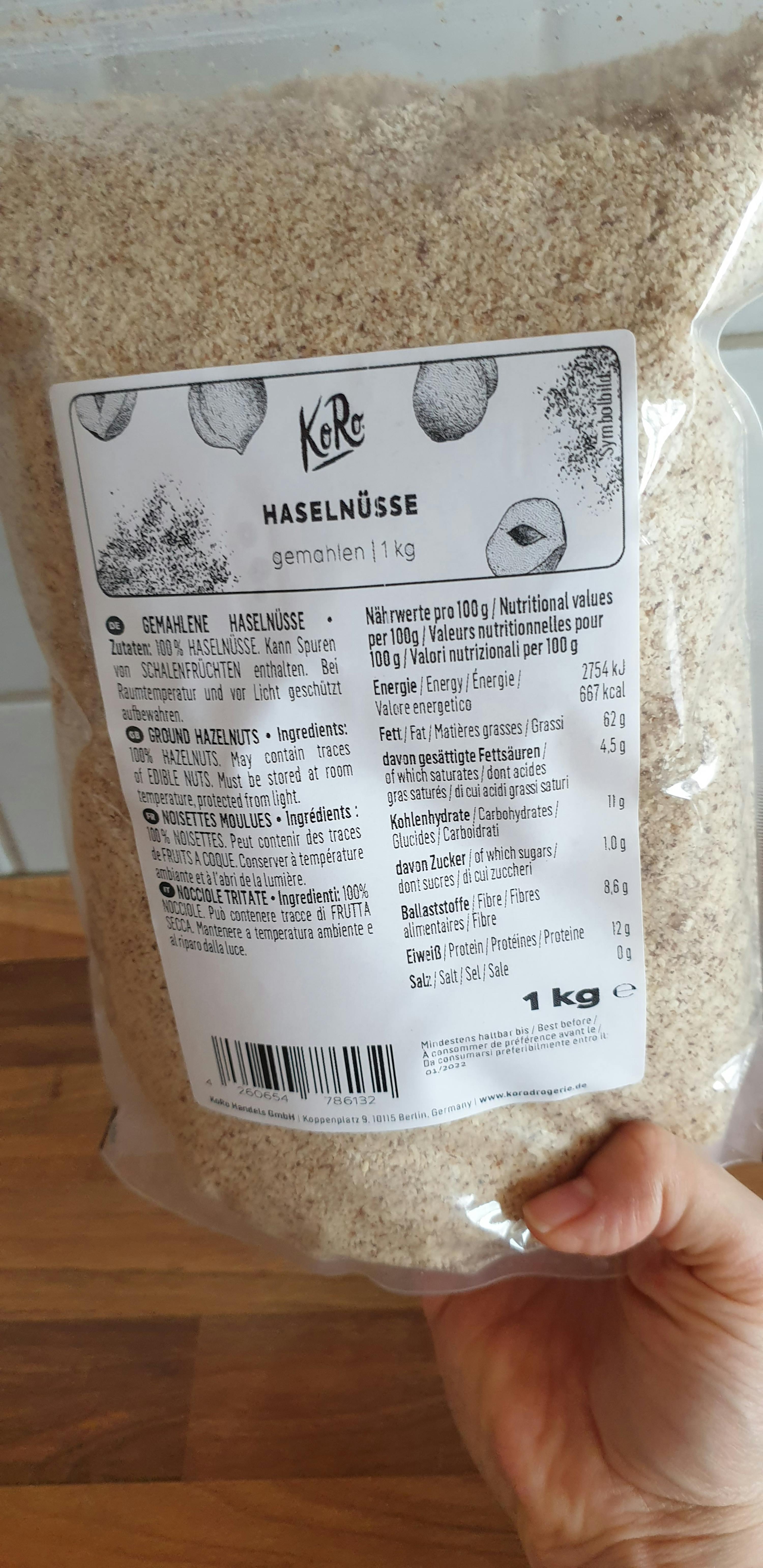 a person is holding a bag of hazelnuts with a label that says 1 kg