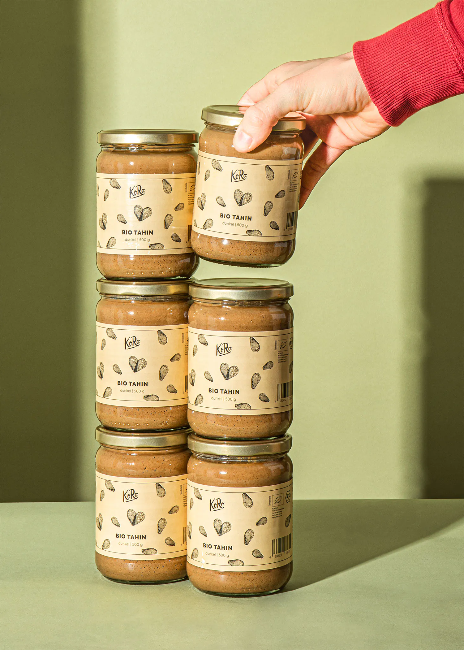 several jars of bio tahin are stacked on top of each other