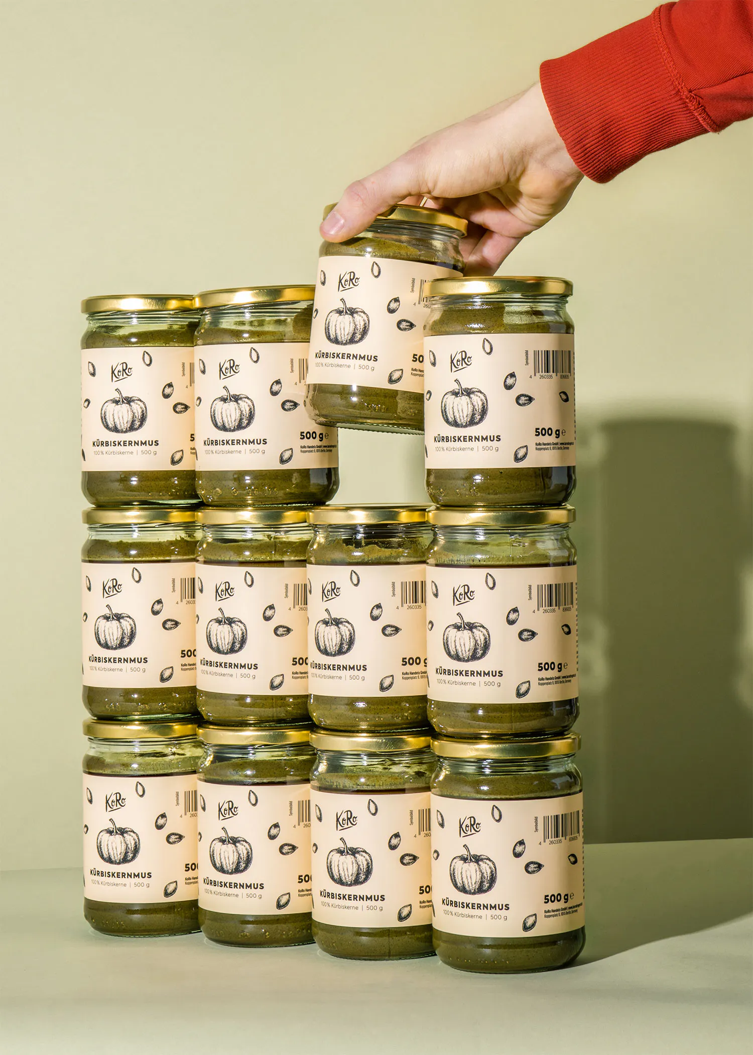 a hand is reaching for a jar of pumpkin seeds