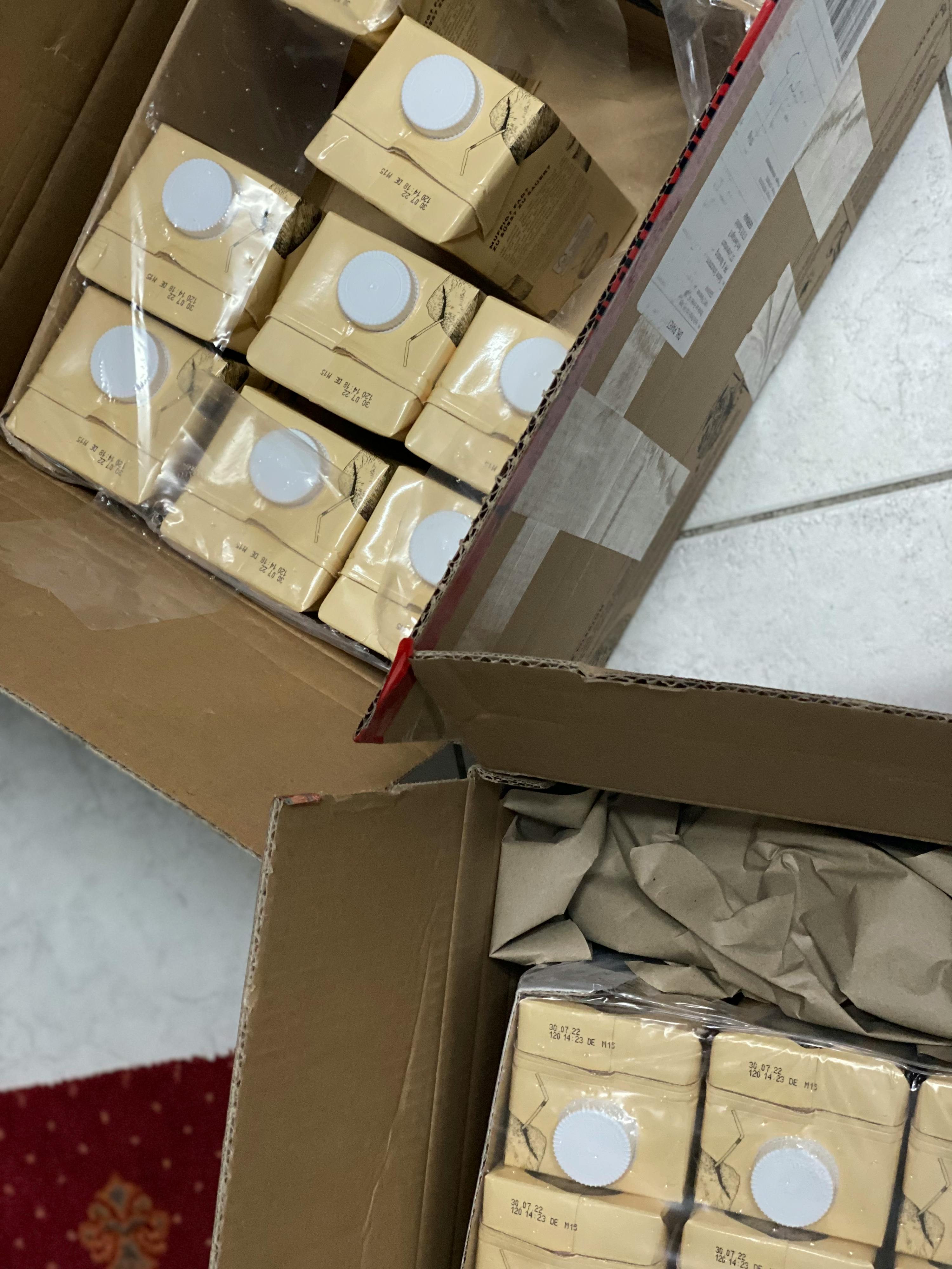 a cardboard box filled with a lot of milk cartons with the numbers 8435 on them