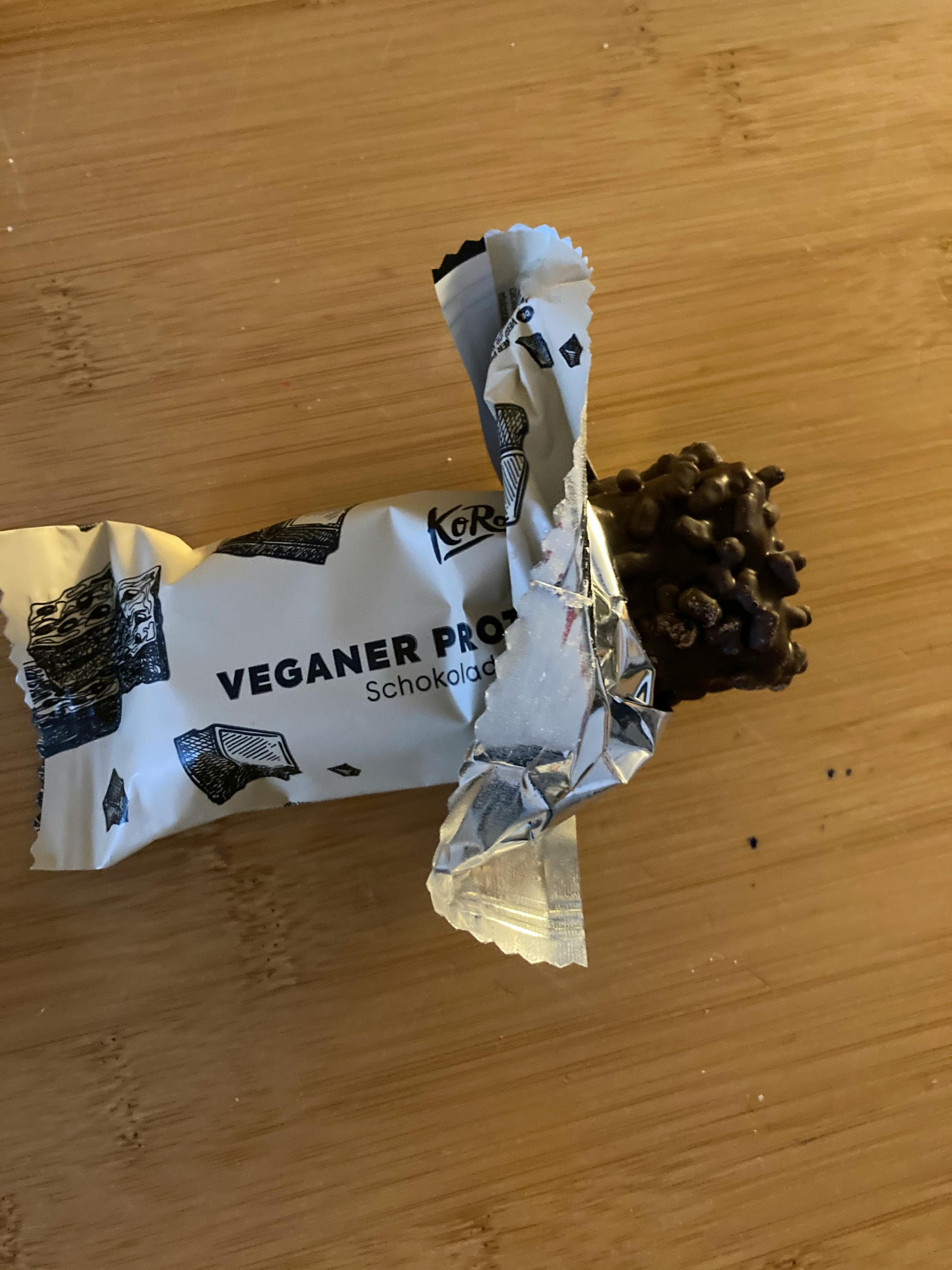 a veganer pro chocolate bar is sitting on a wooden table