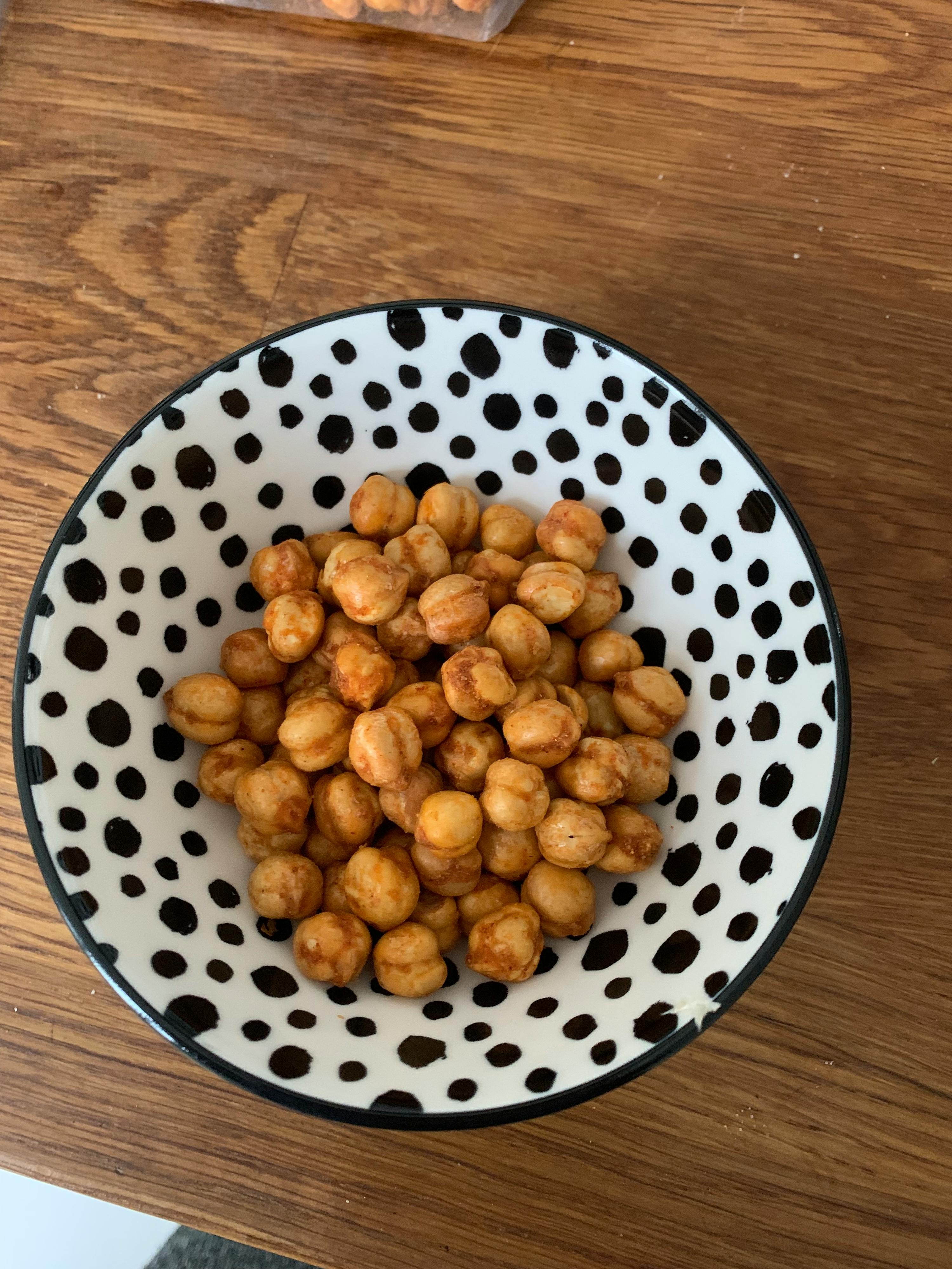 a black and white polka dot bowl filled with chickpeas