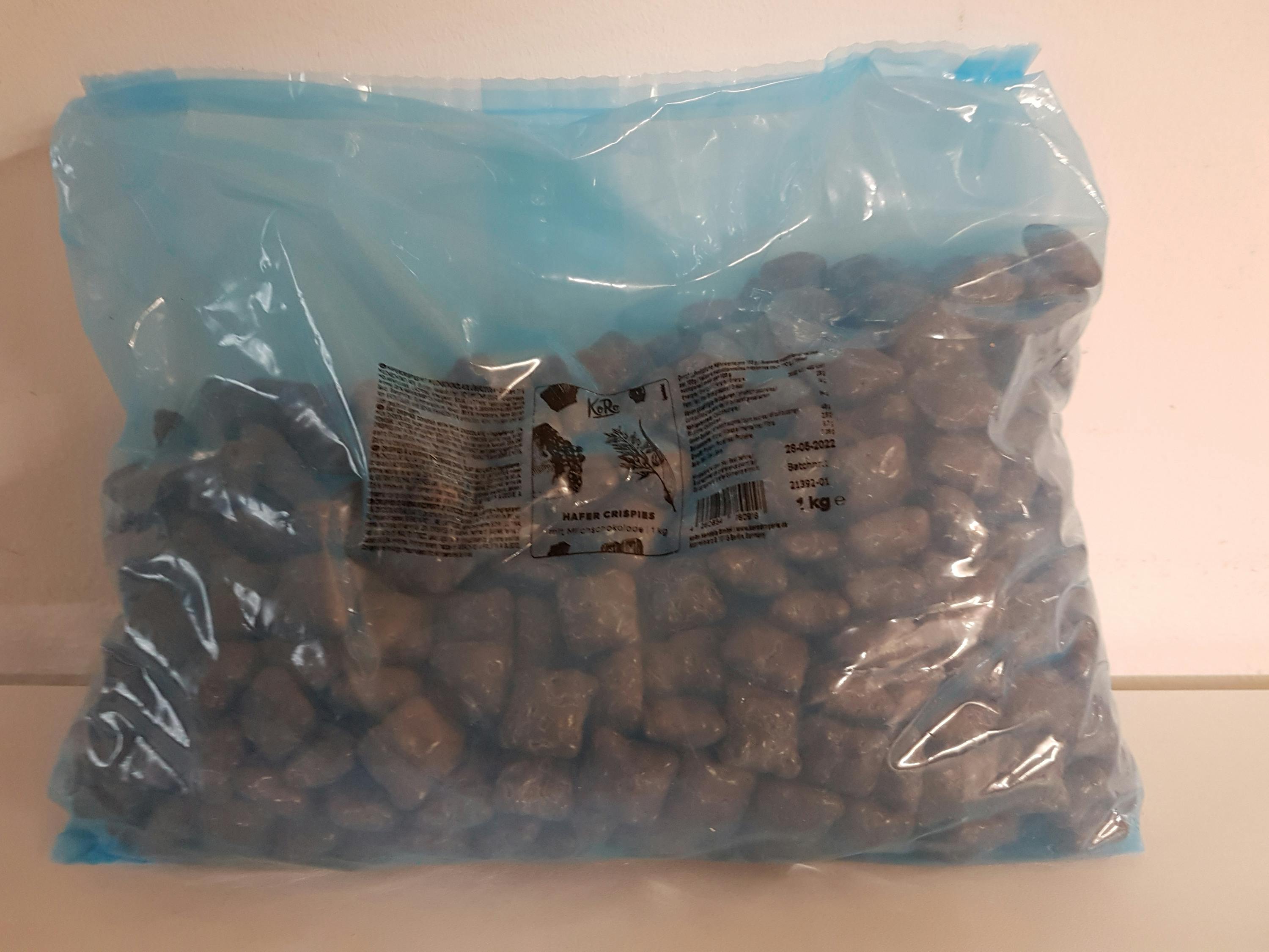 a bag of chocolate covered marshmallows is sitting on a white surface