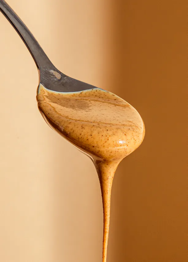 un gros plan d' une cuillère remplie de beurre d' arachide