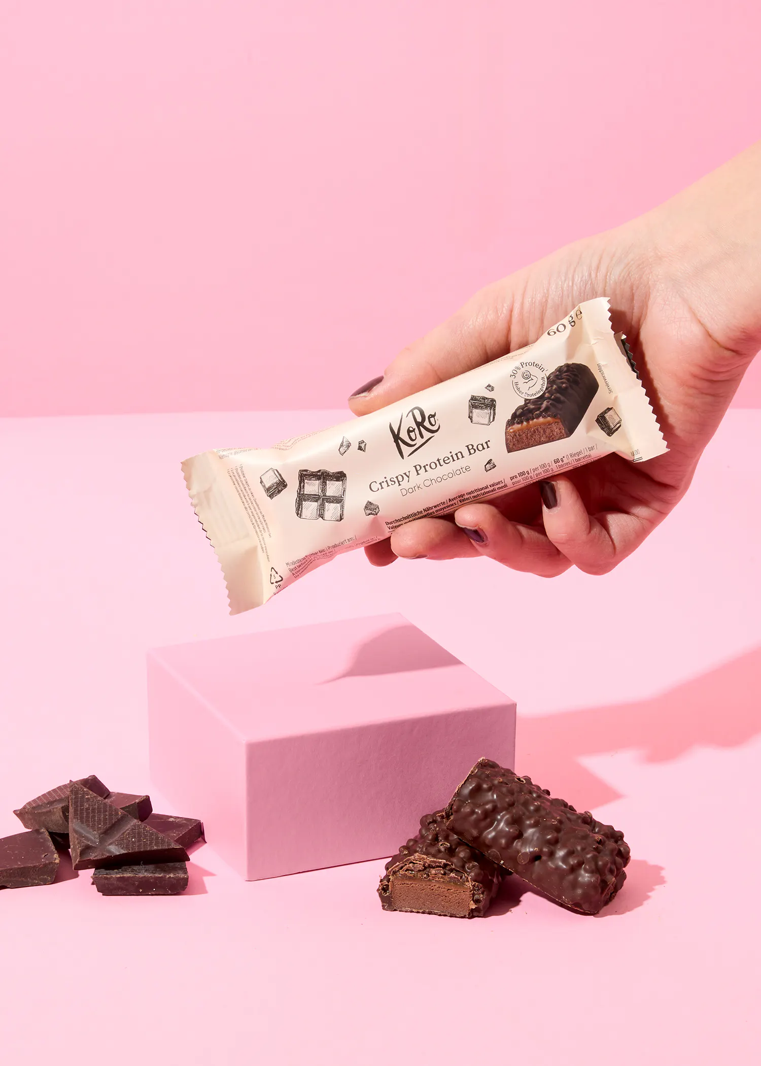 une personne tient une barre de proteine croustillante