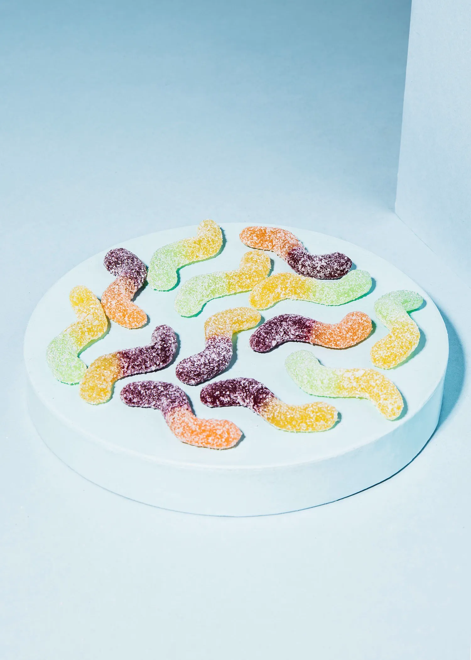 a bunch of gummy worms on a white plate