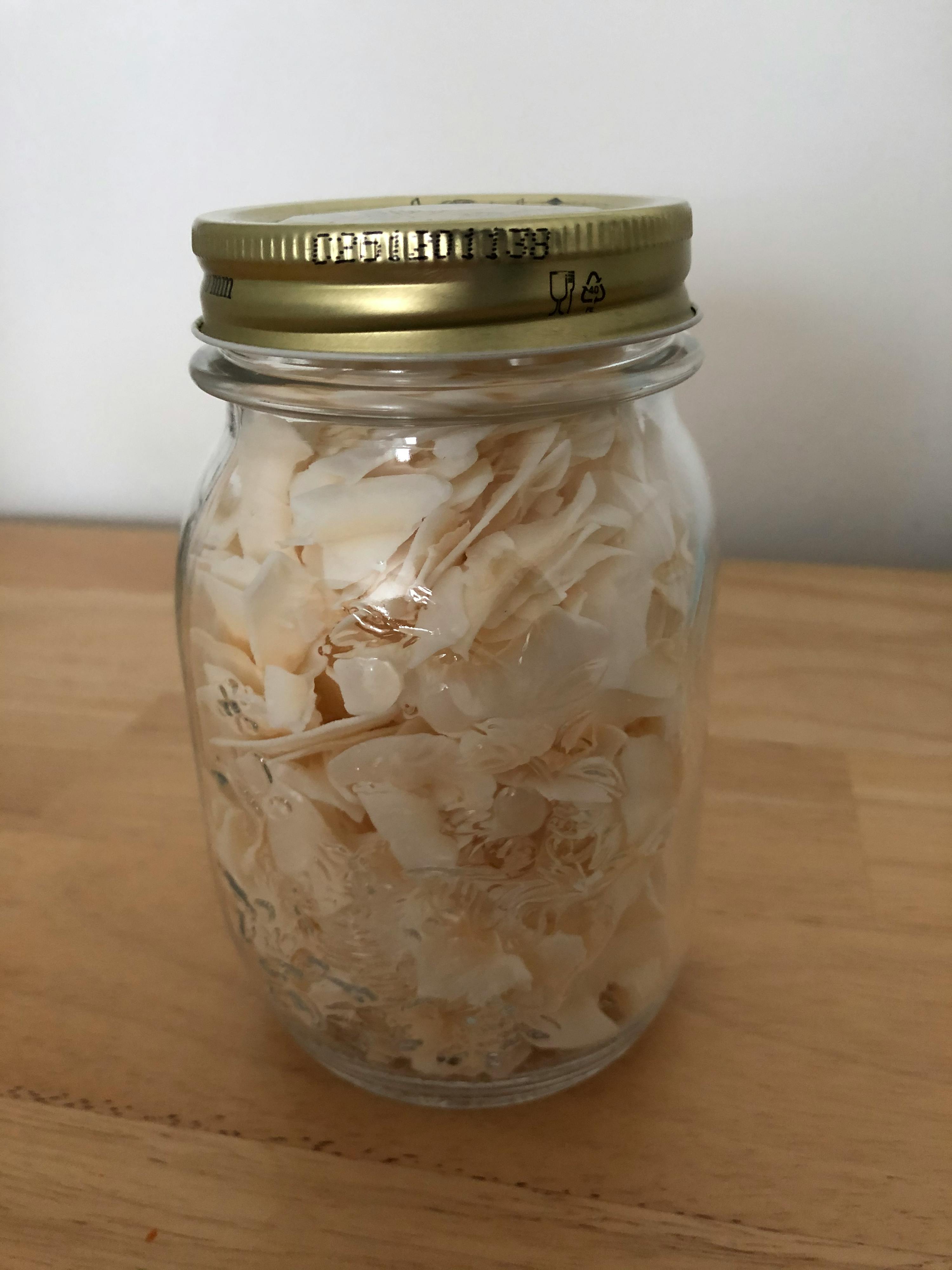 a jar with a gold lid that says best before on it