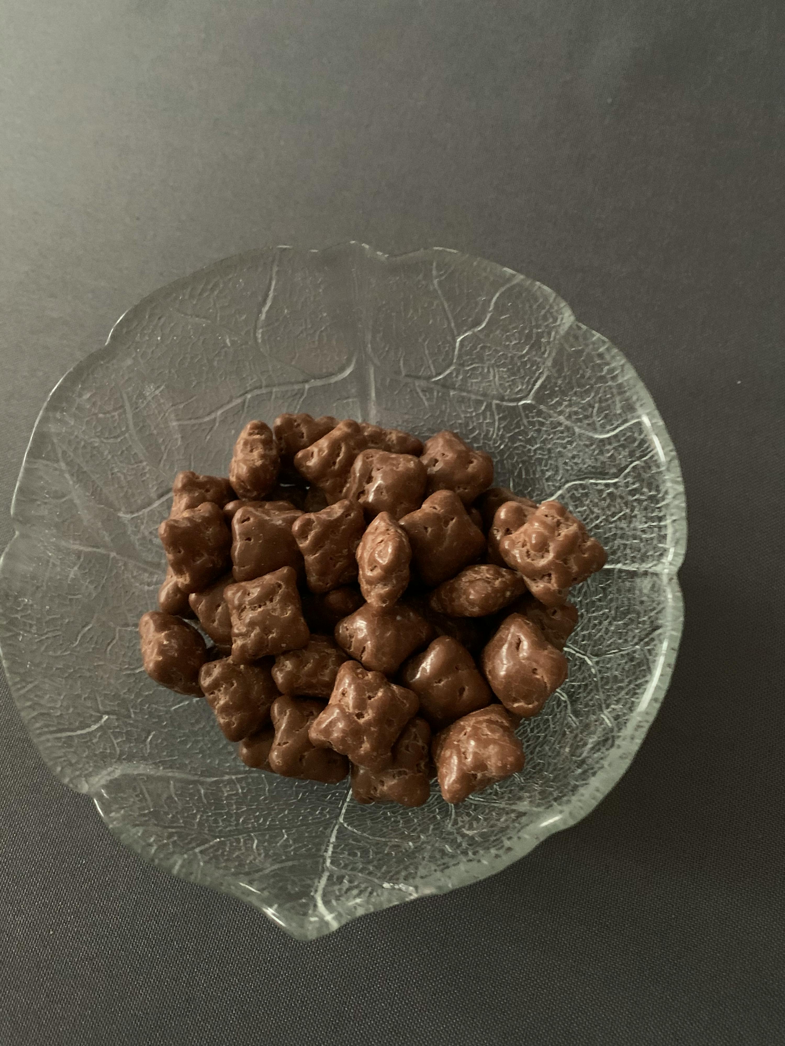 a glass bowl filled with chocolate covered popcorn bears