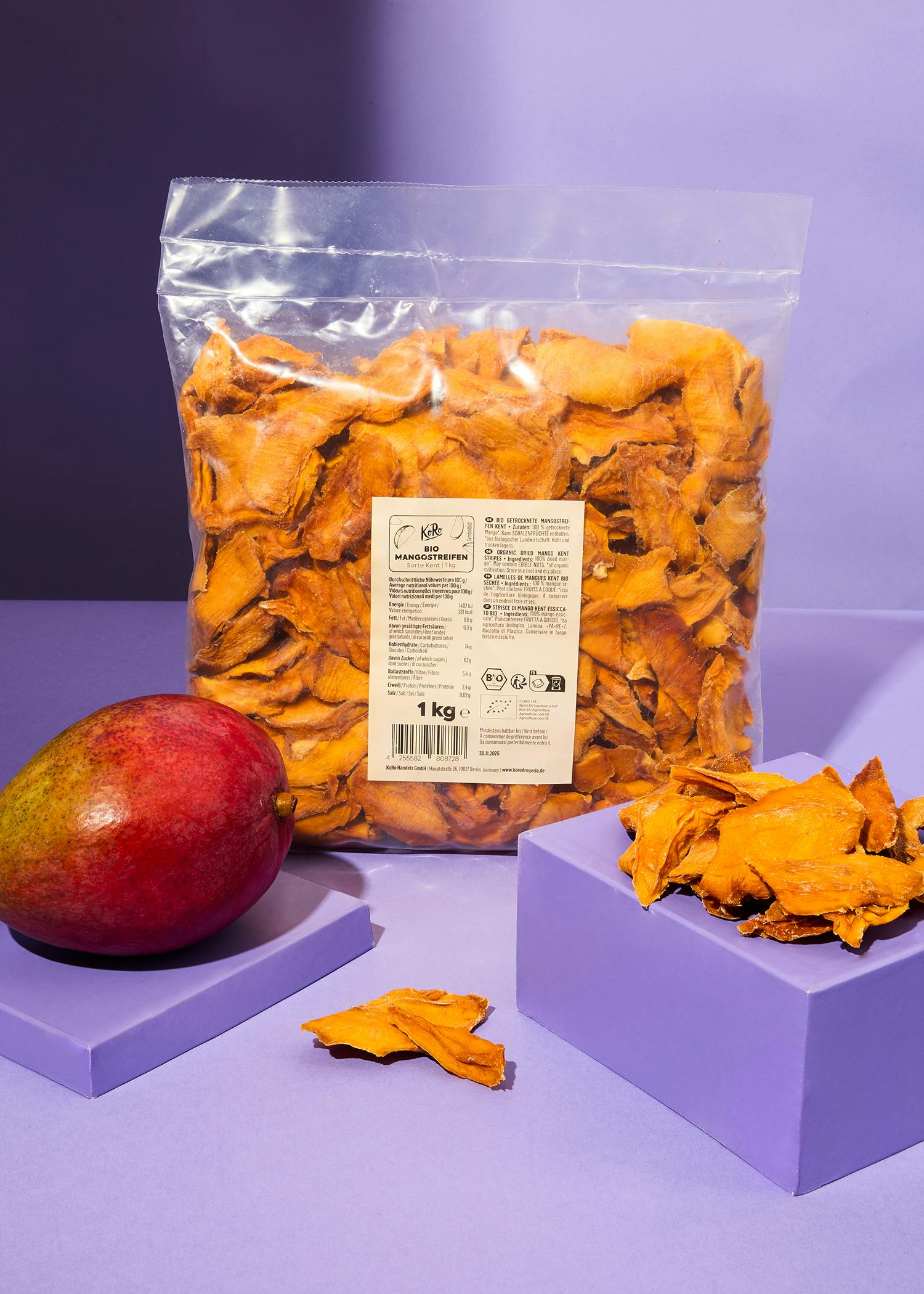 Organic Kent mango strips 1kg a bag of dried mango slices sits next to a mango