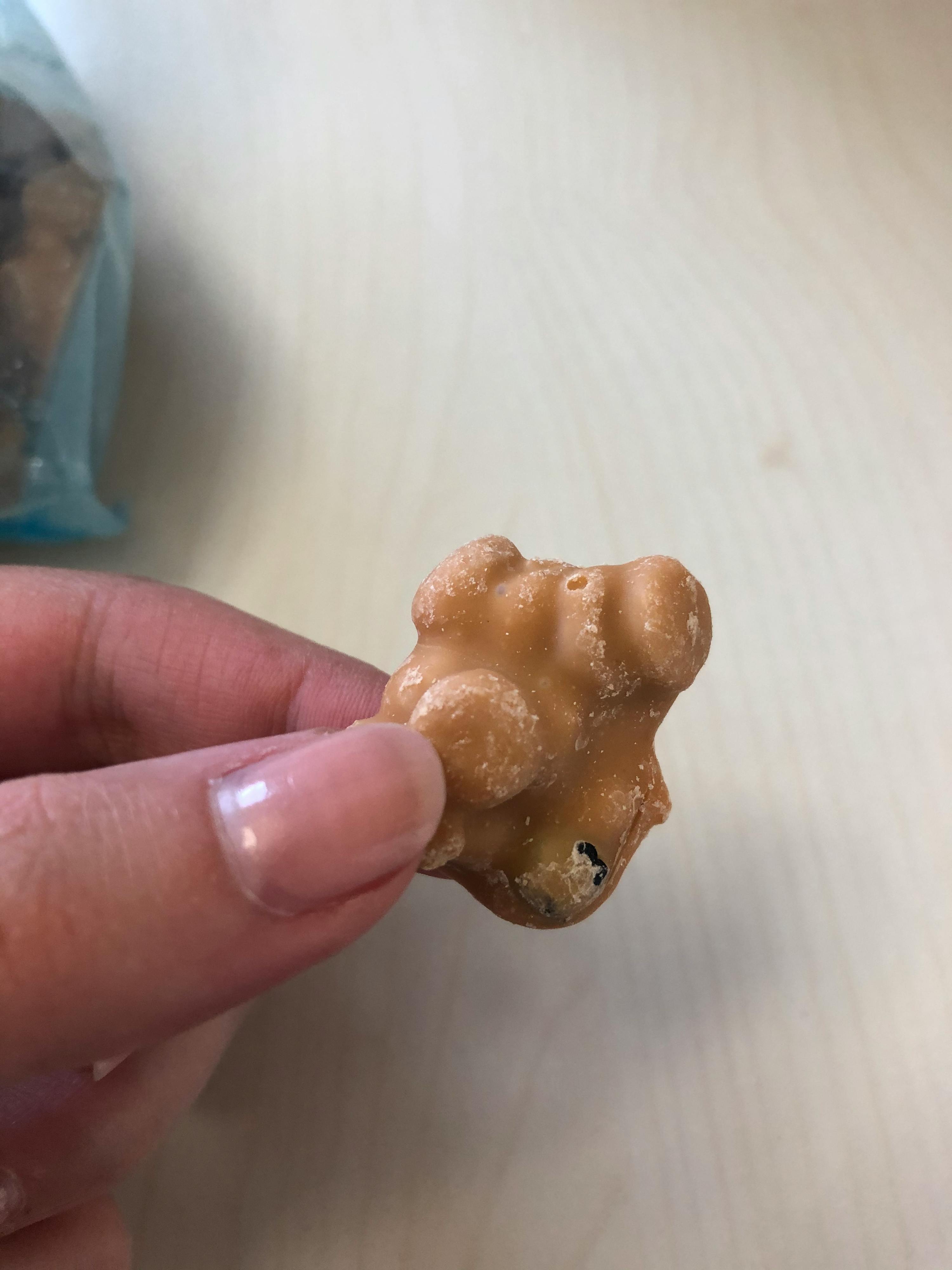 a person is holding a piece of chocolate in their hand