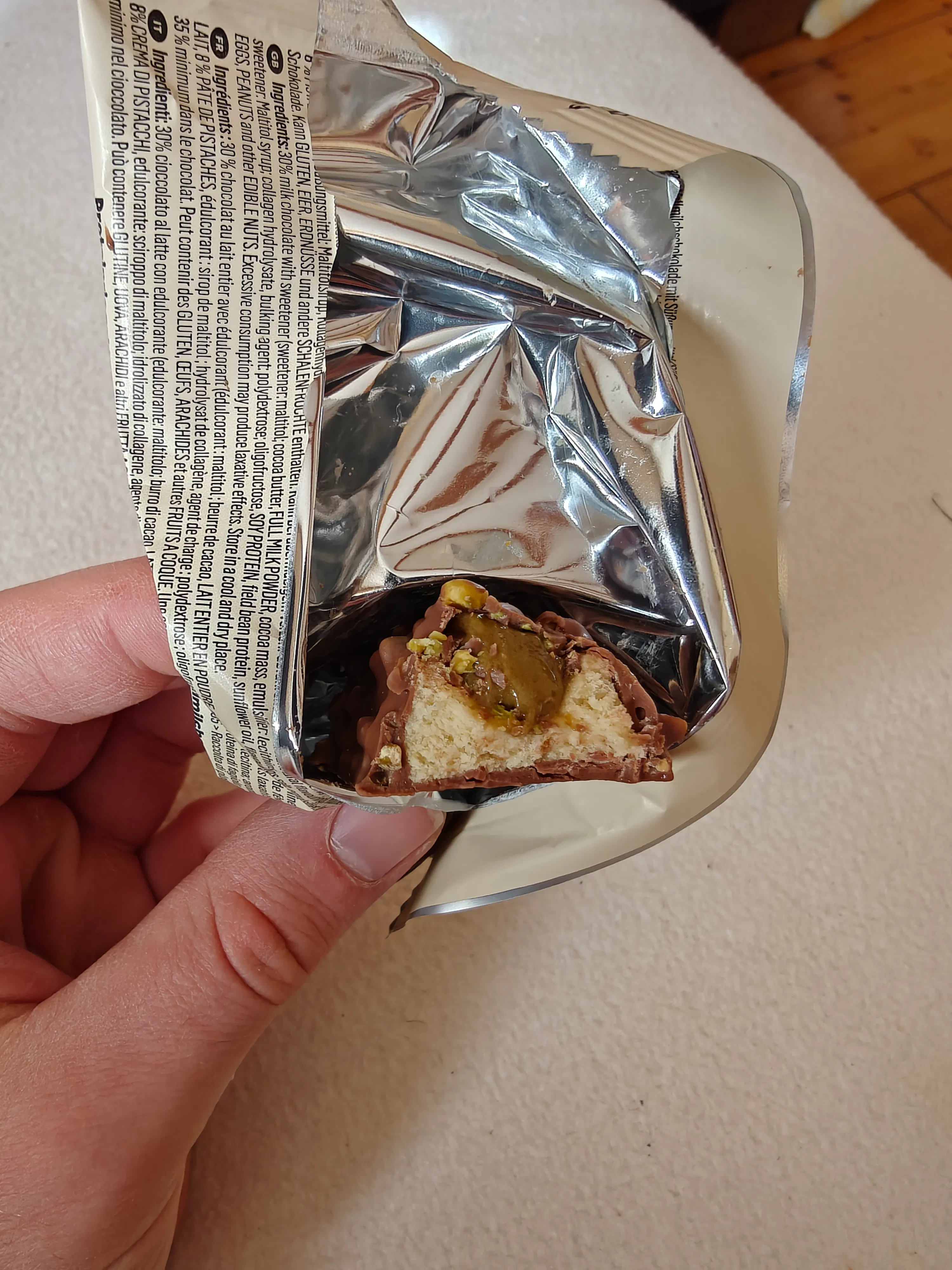 une personne tient une barre de chocolat avec un morceau coupé dedans