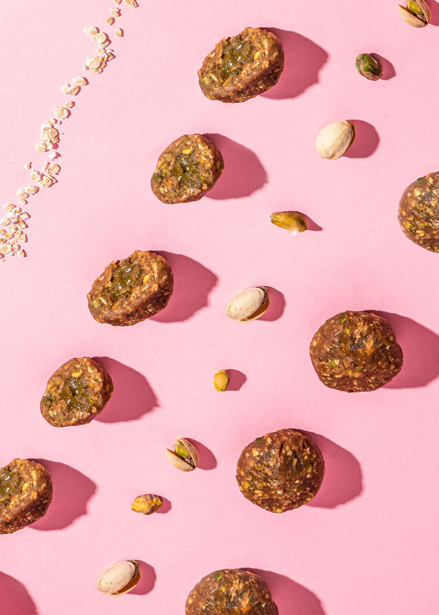 a pink background with pistachios and nuts on it
