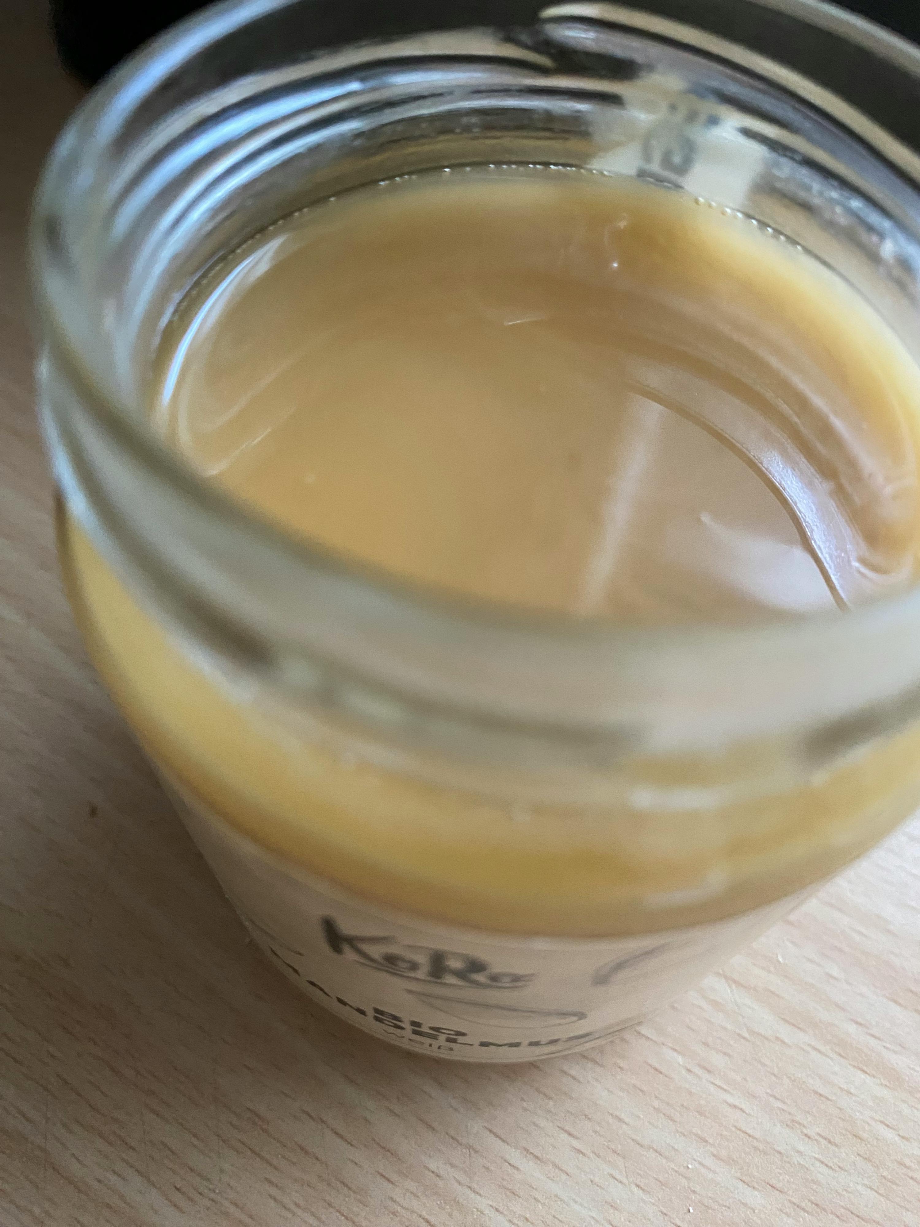 a close up of a jar of ketchup on a table