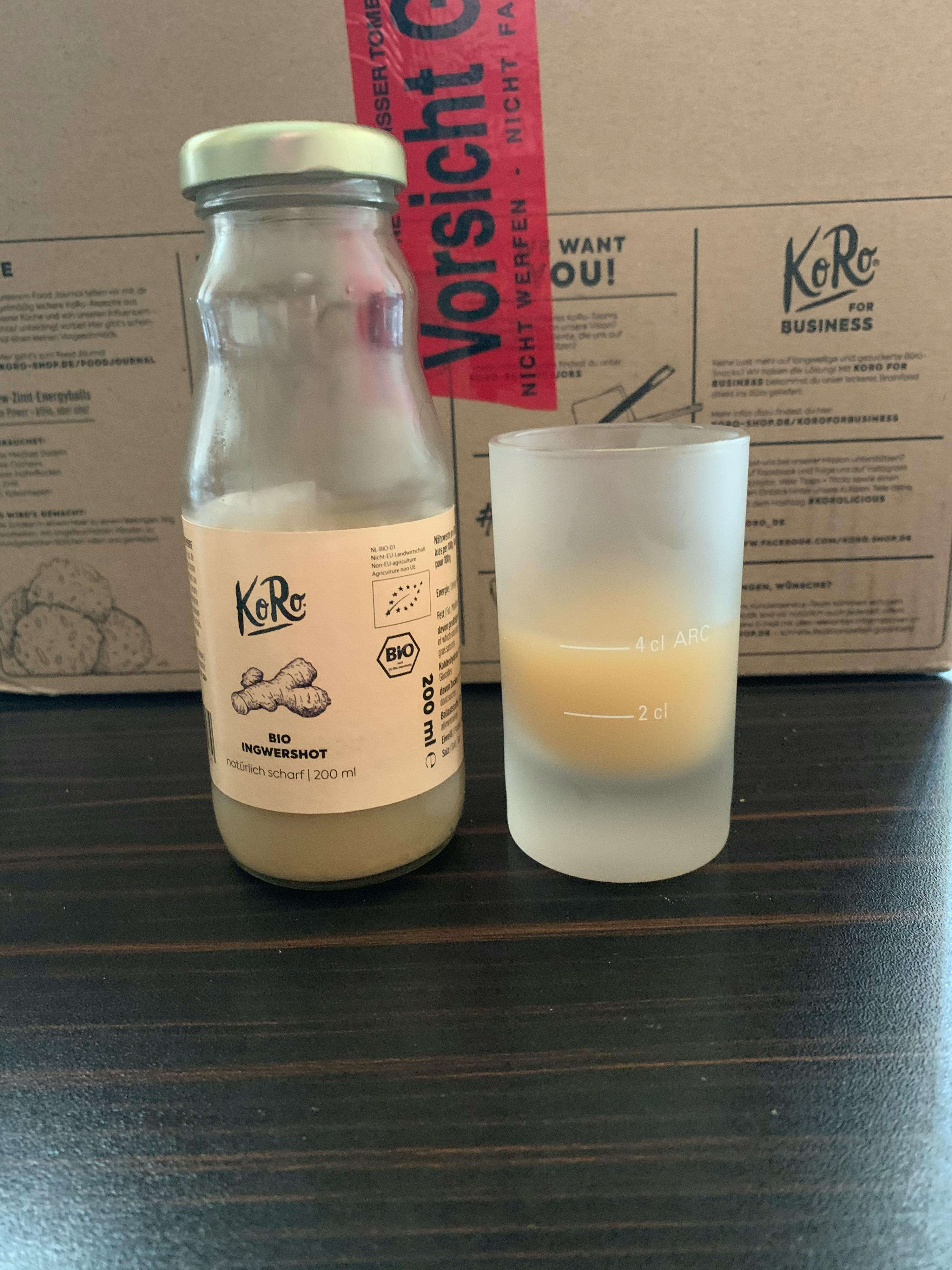 a bottle of ginger beer next to a glass