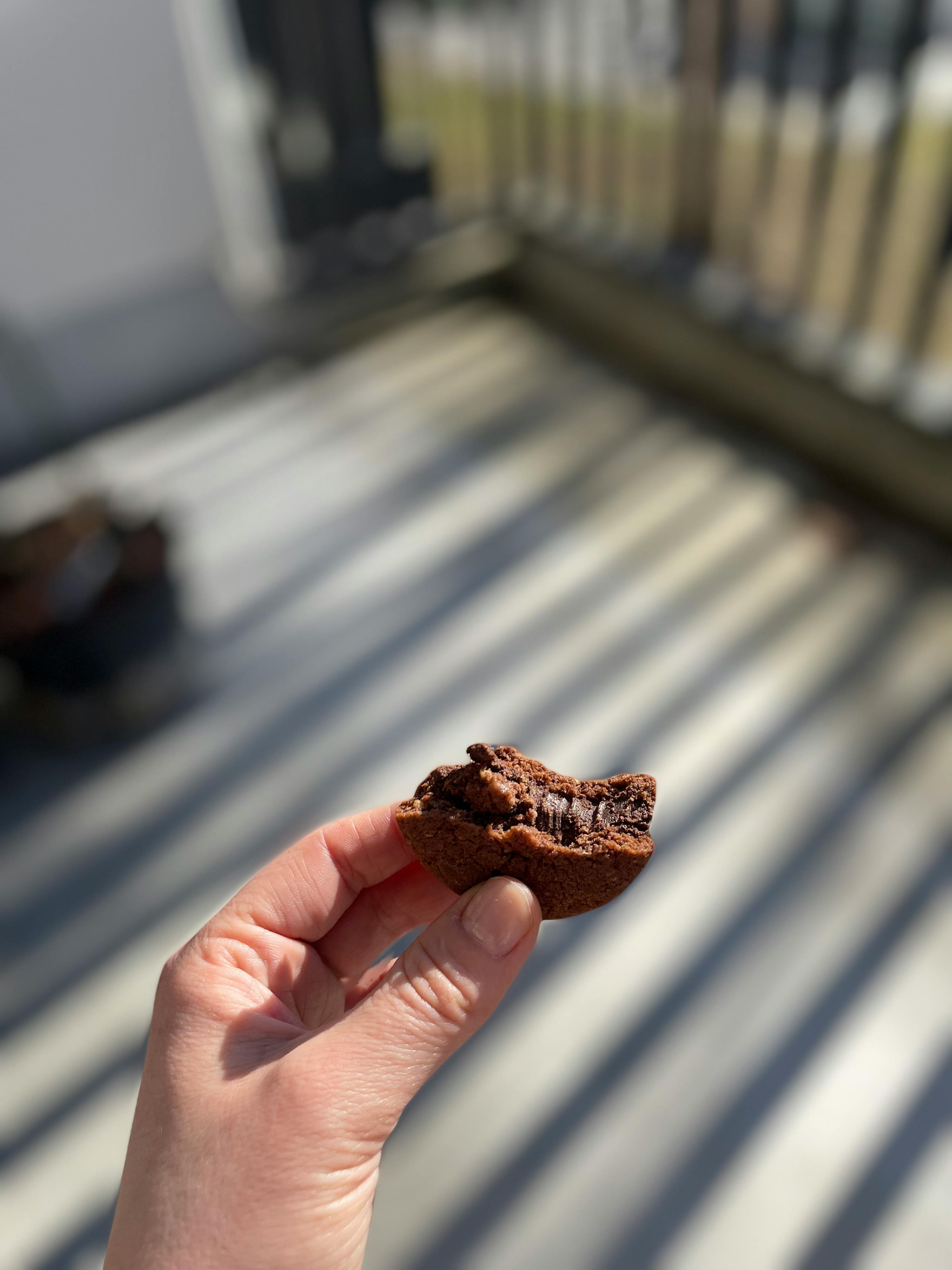 eine Person hält einen Schokoladenkuchen in der Hand