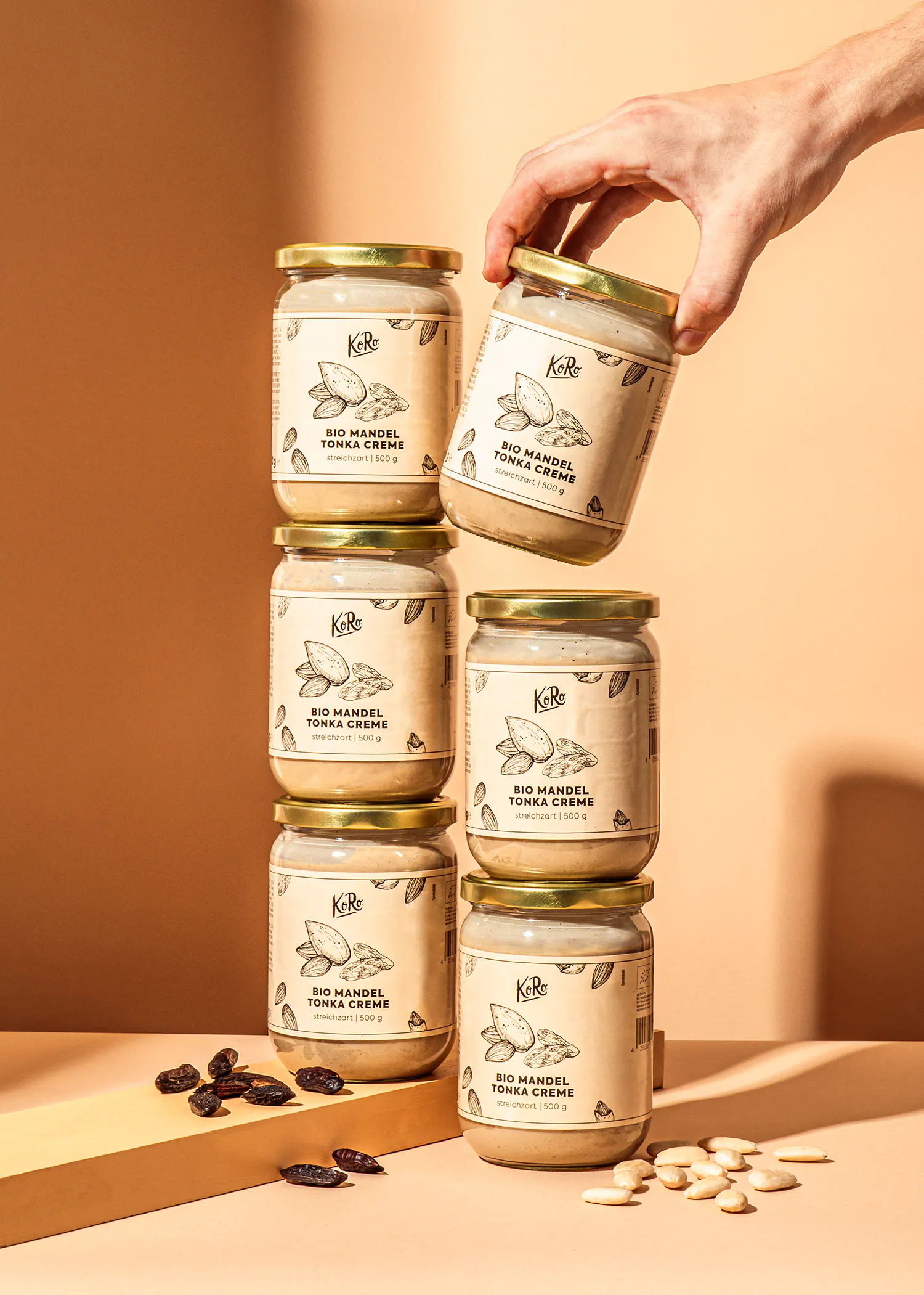 a hand is holding a jar of bio mandel creme