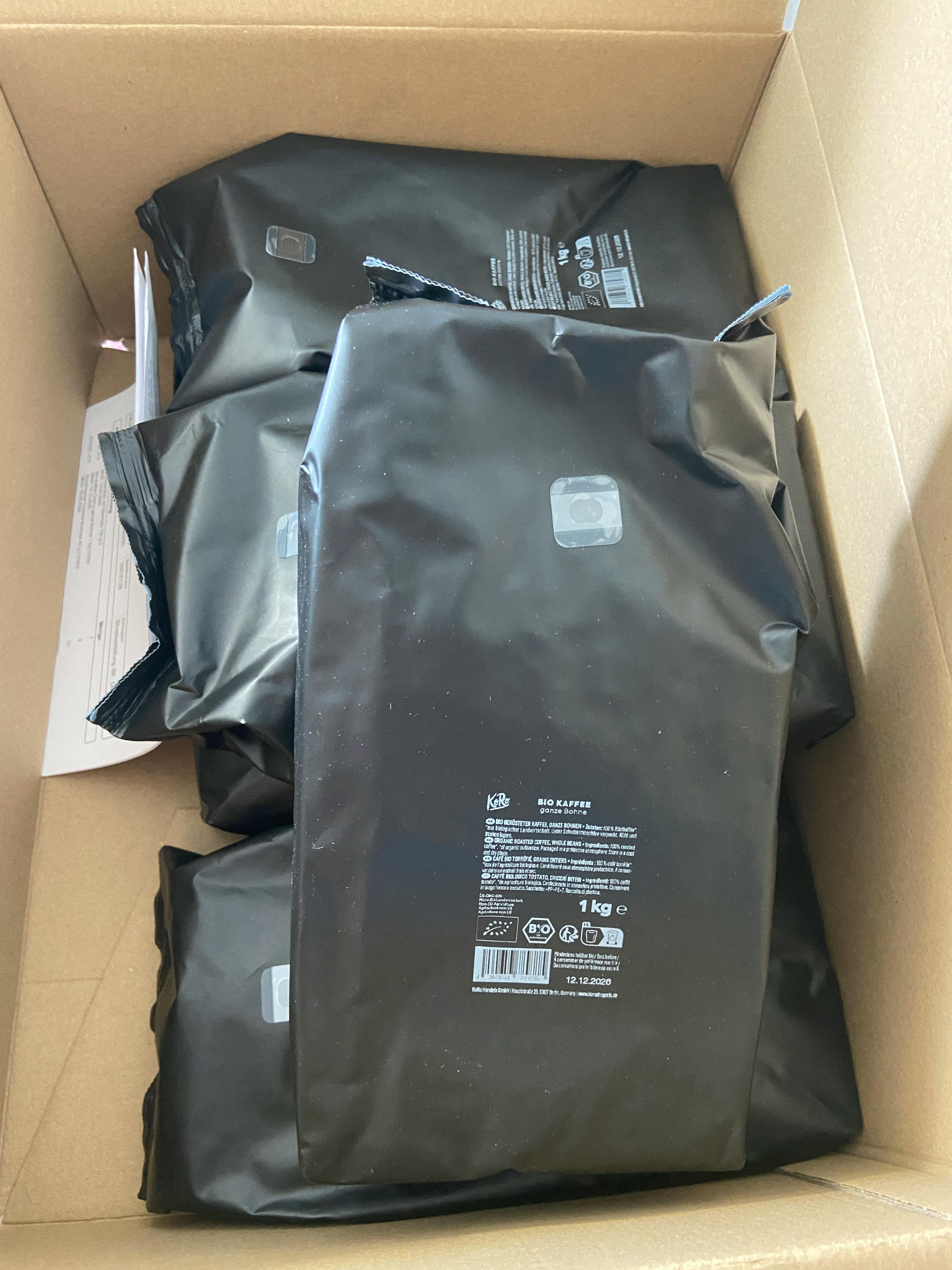 une boîte en carton remplie de sacs de nourriture noirs