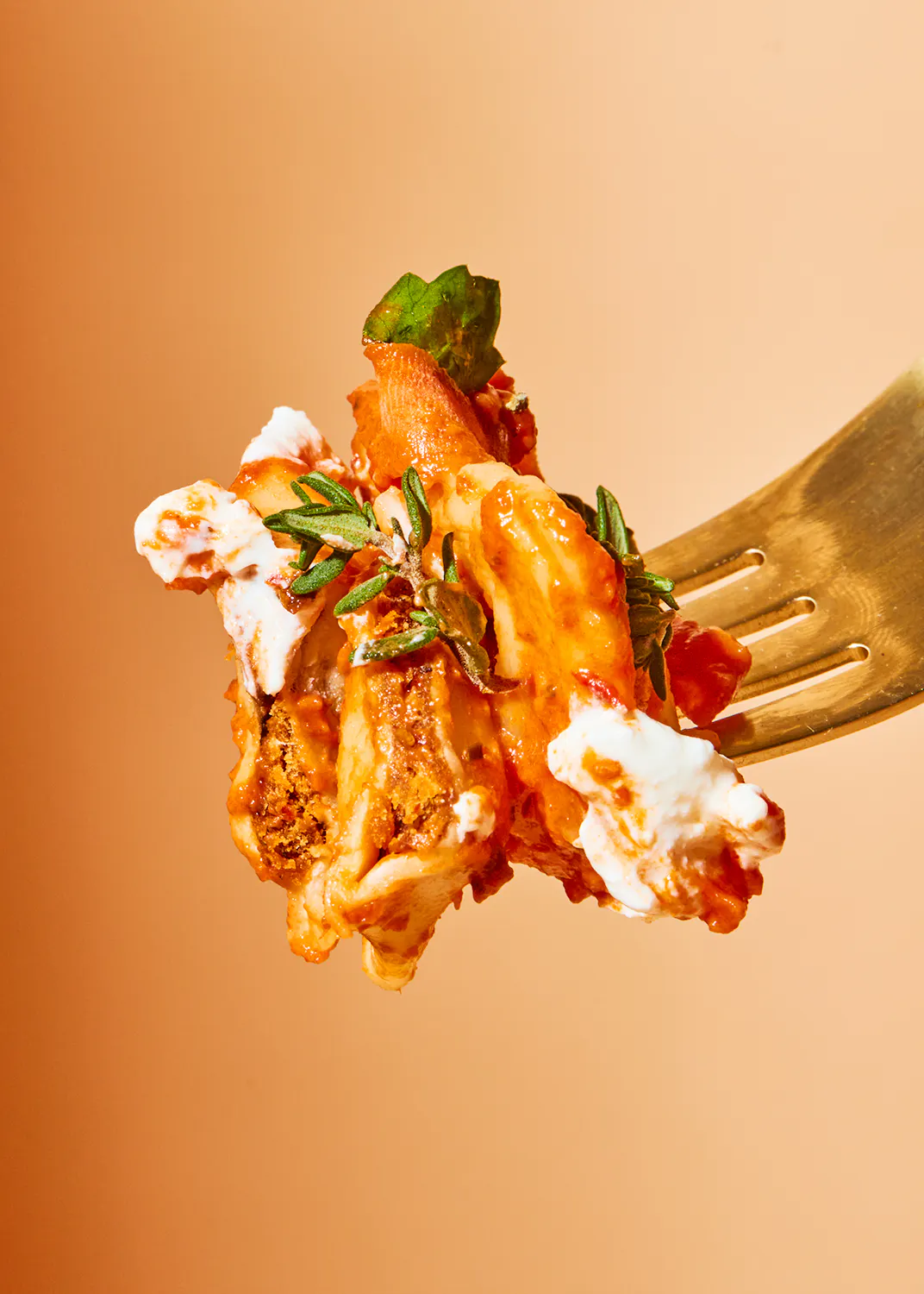 a close up of a fork with a piece of food on it