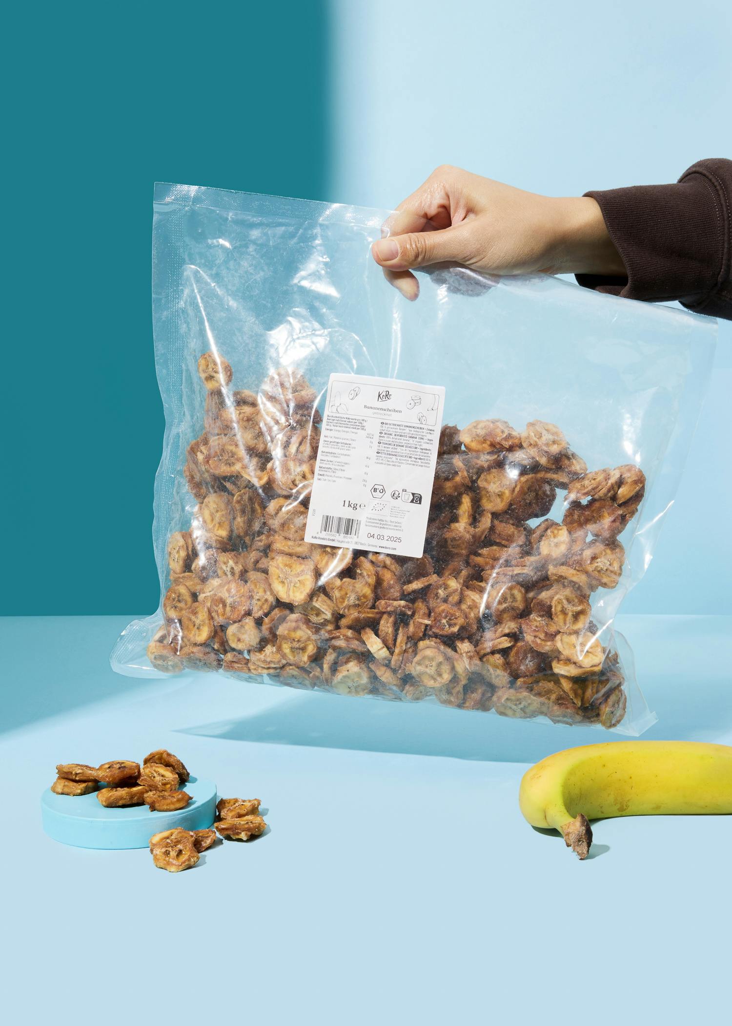 a person is holding a bag of banana chips