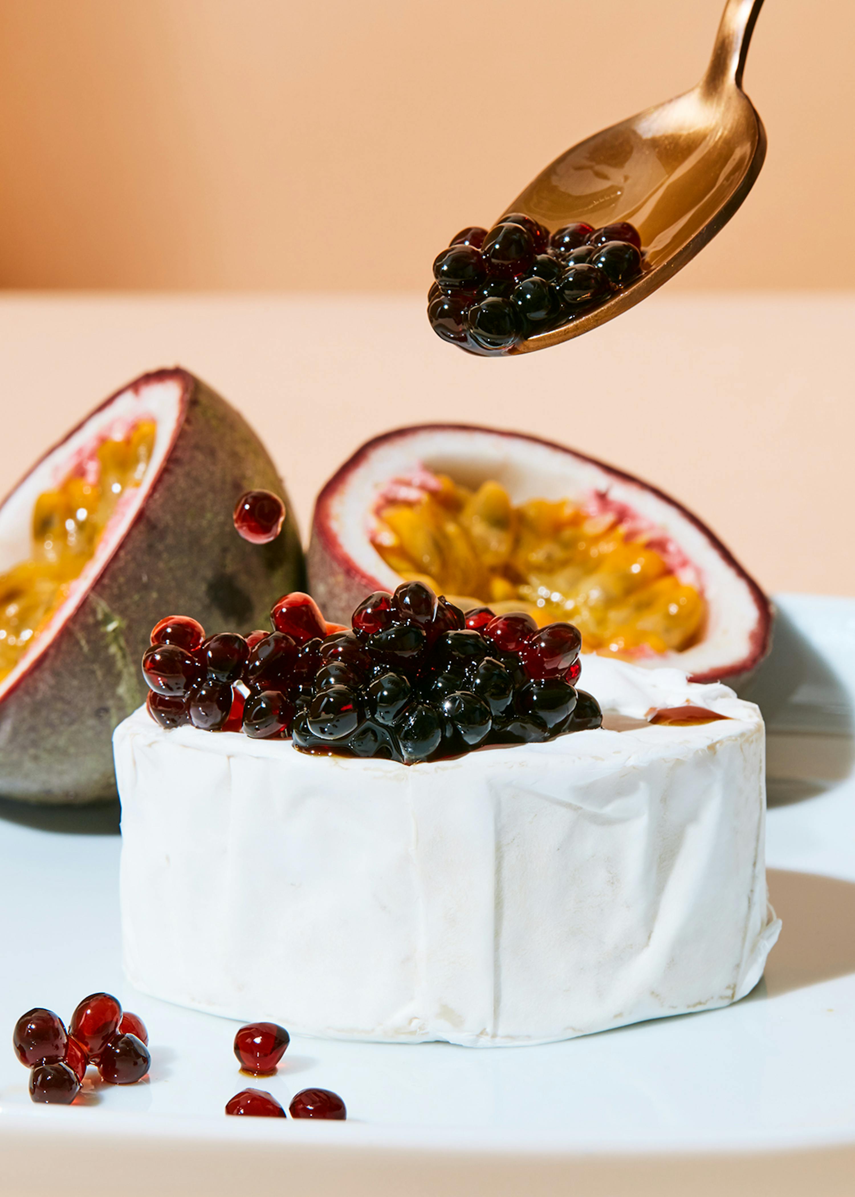 a spoon is being used to pour a sauce on a piece of cheese