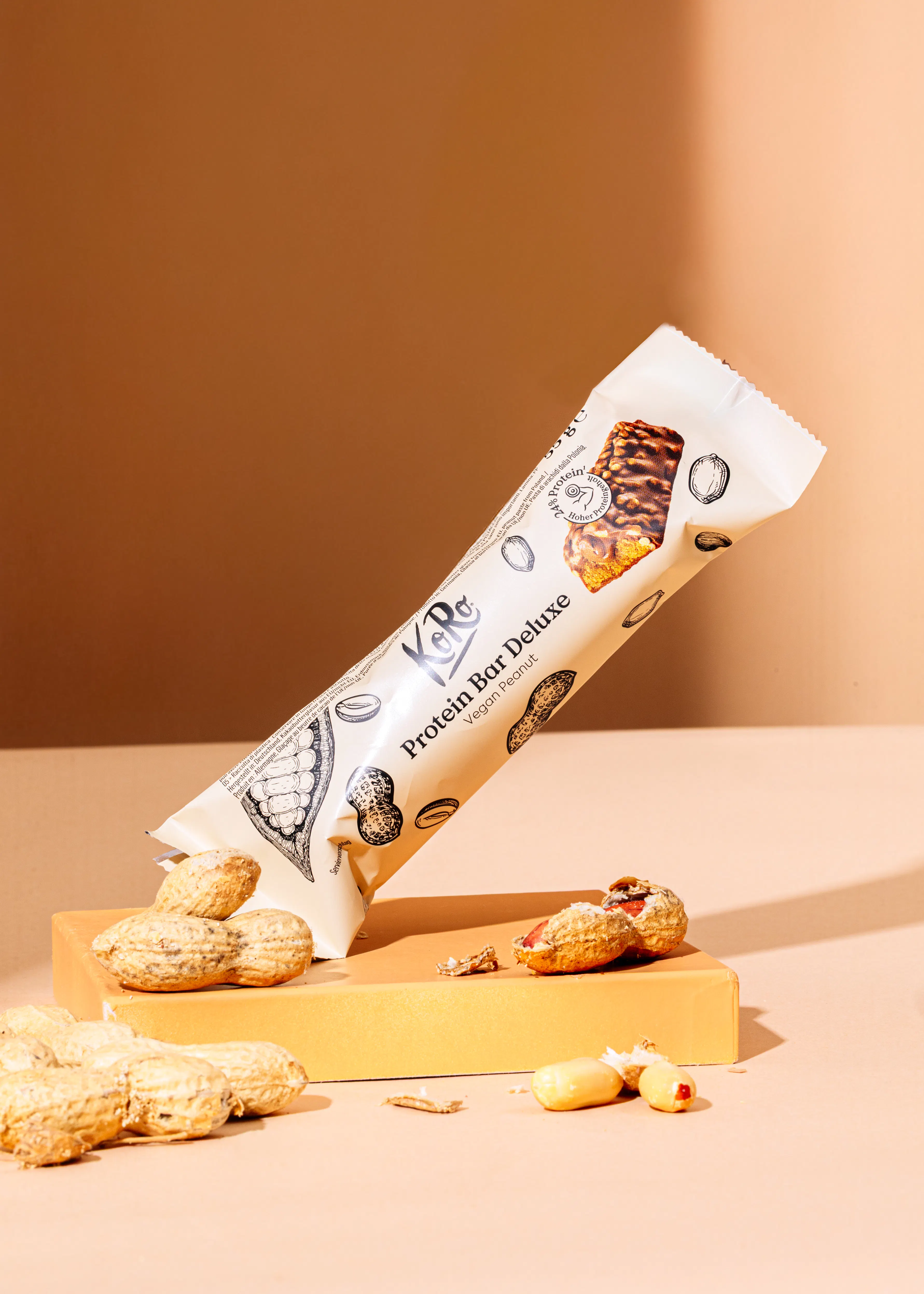 a protein bar deluxe is sitting on a table next to peanuts