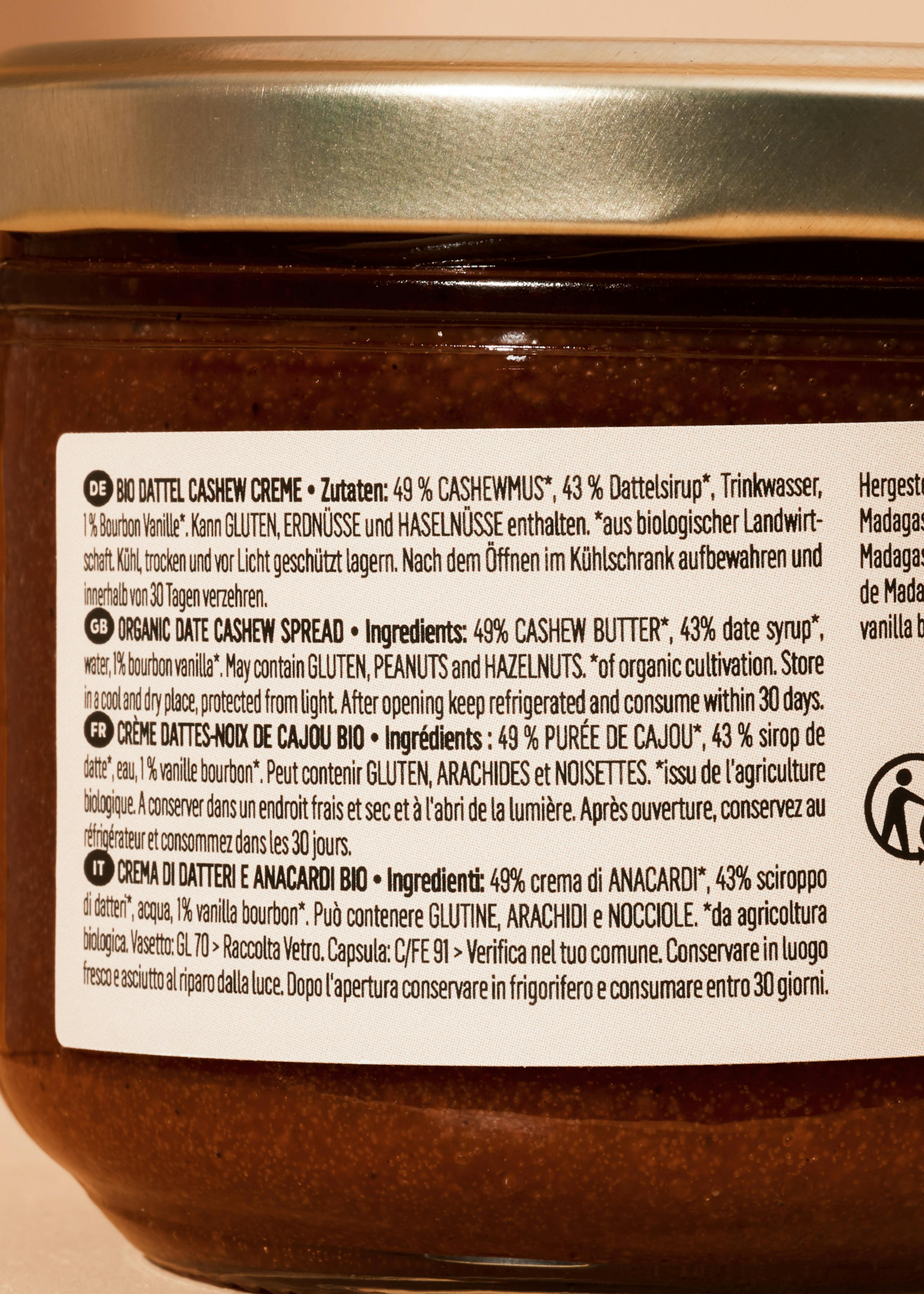 a jar of organic date cashew spread with a label detailing ingredients and storage instructions in multiple languages.
