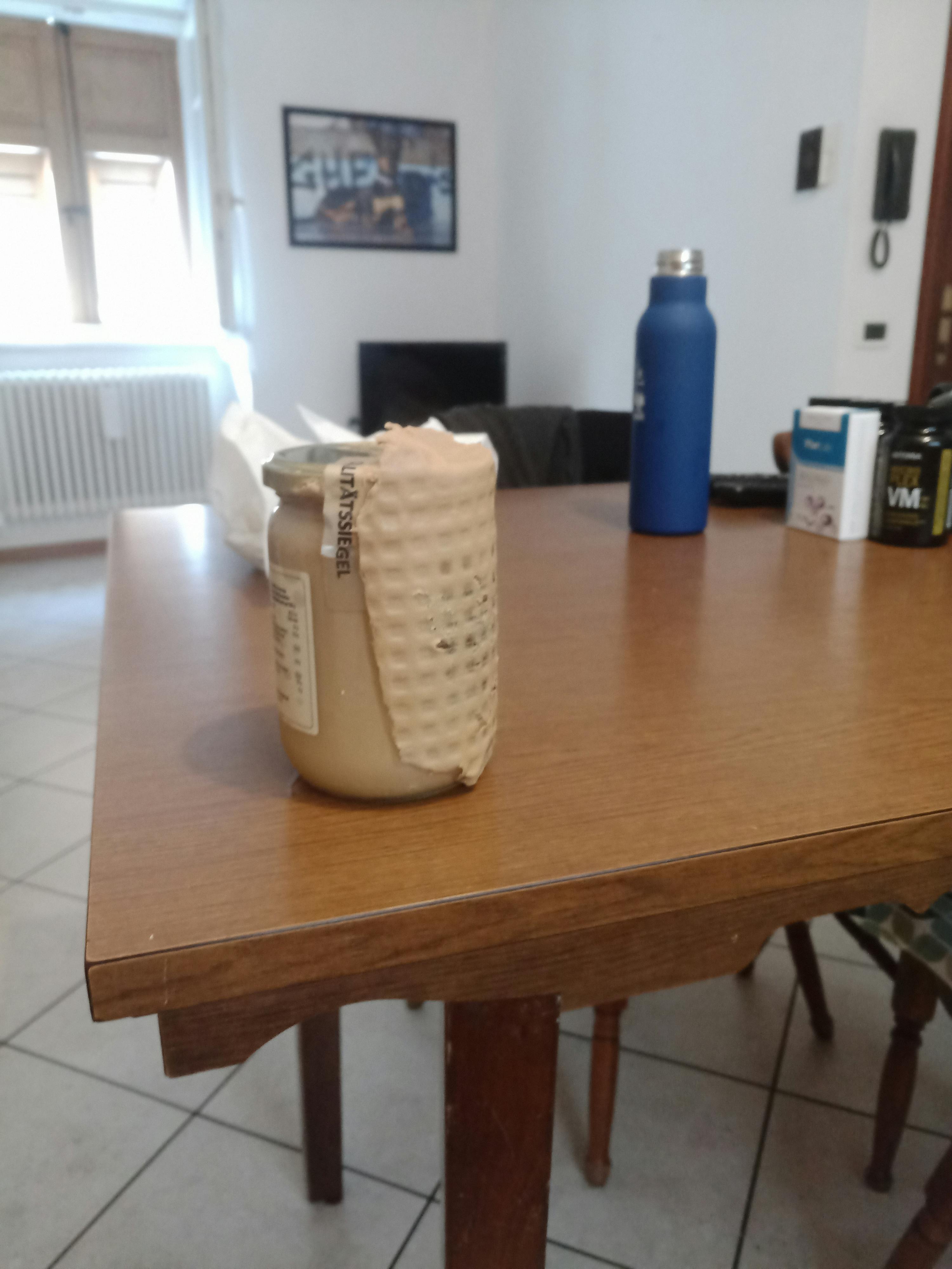 a jar with a label that says ' ultrasteel ' on it sits on a wooden table