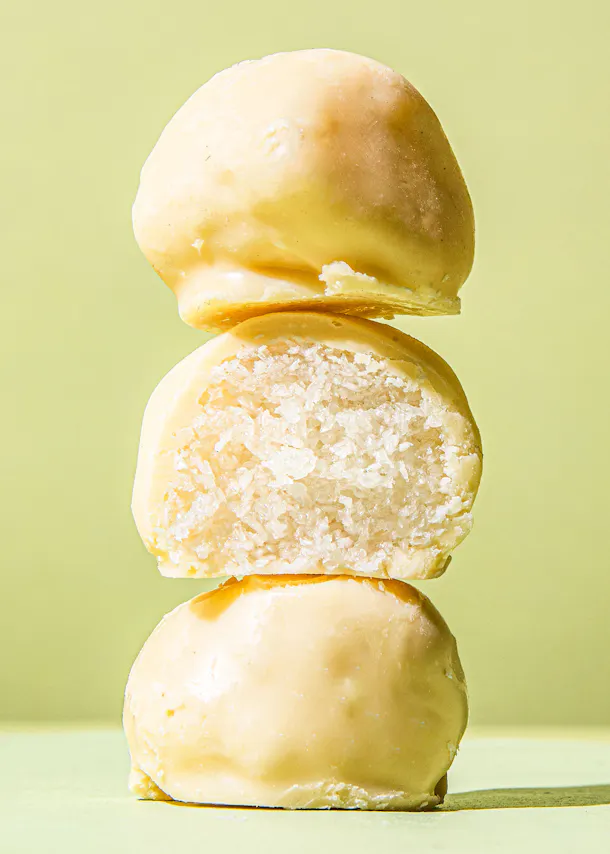 three doughnuts are stacked on top of each other on a green surface