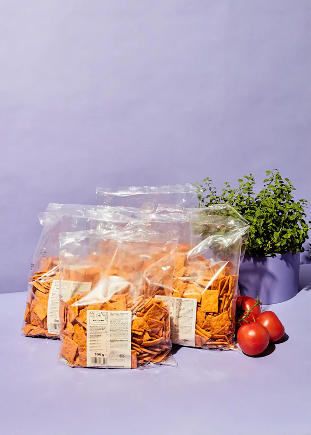 three bags of tortilla chips are sitting on a table