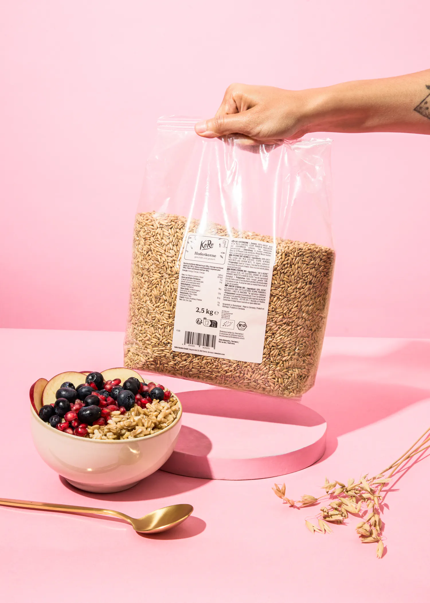 a person is holding a bag of oatmeal next to a bowl of oatmeal