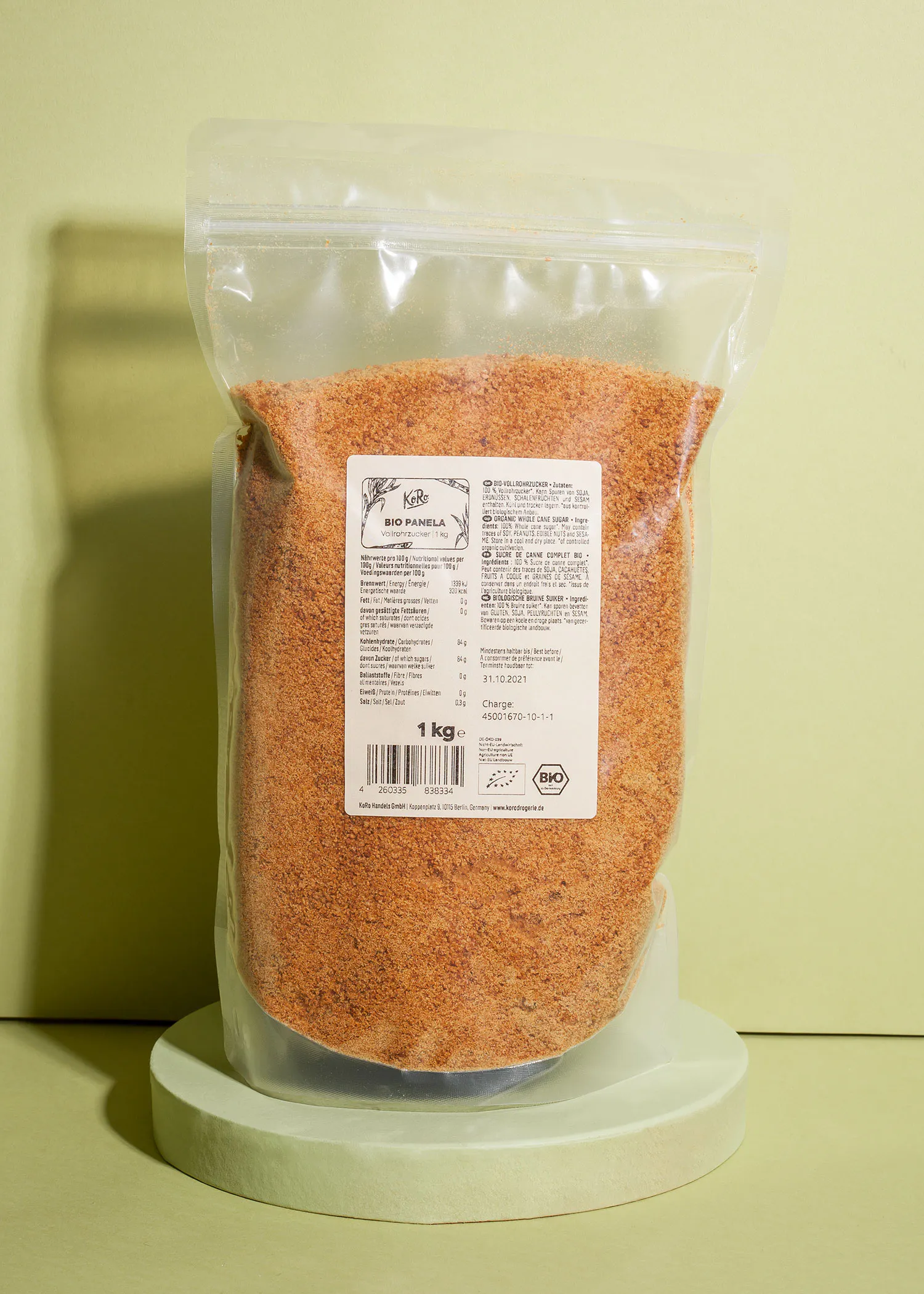 a bag of red chilli powder is sitting on a green podium