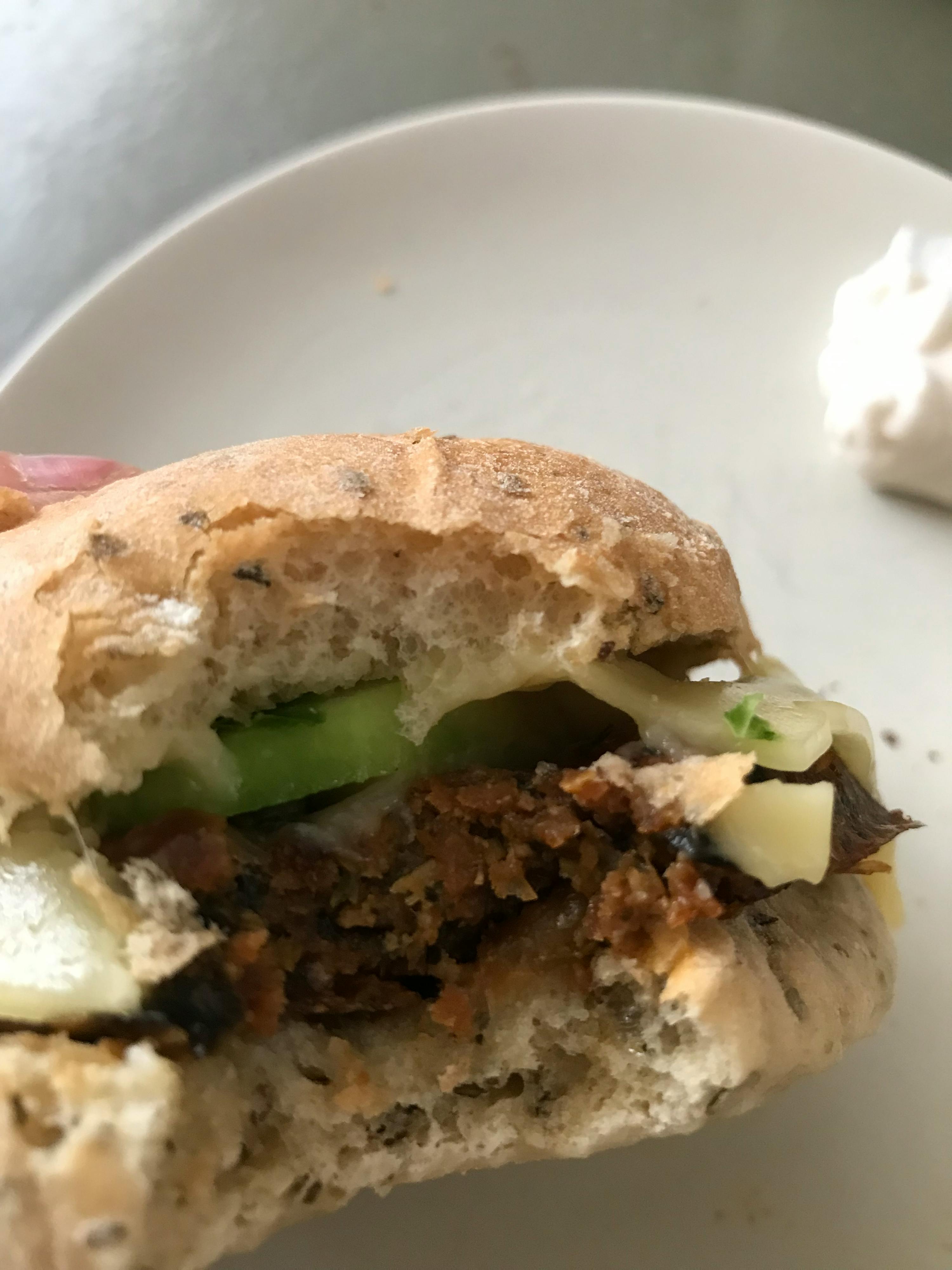 a close up of a sandwich with a bite taken out of it