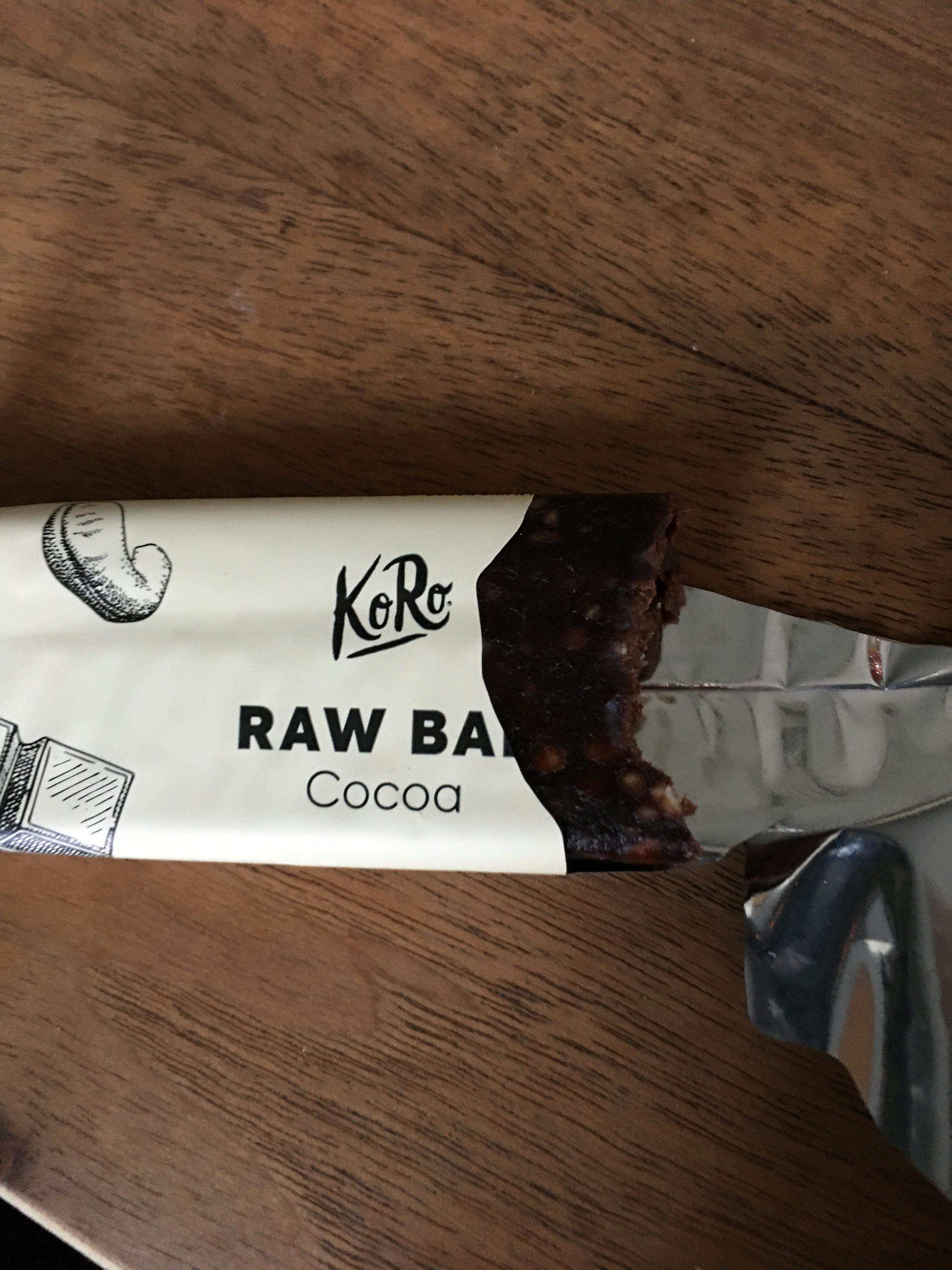 a raw bar with a bite taken out of it sits on a wooden table