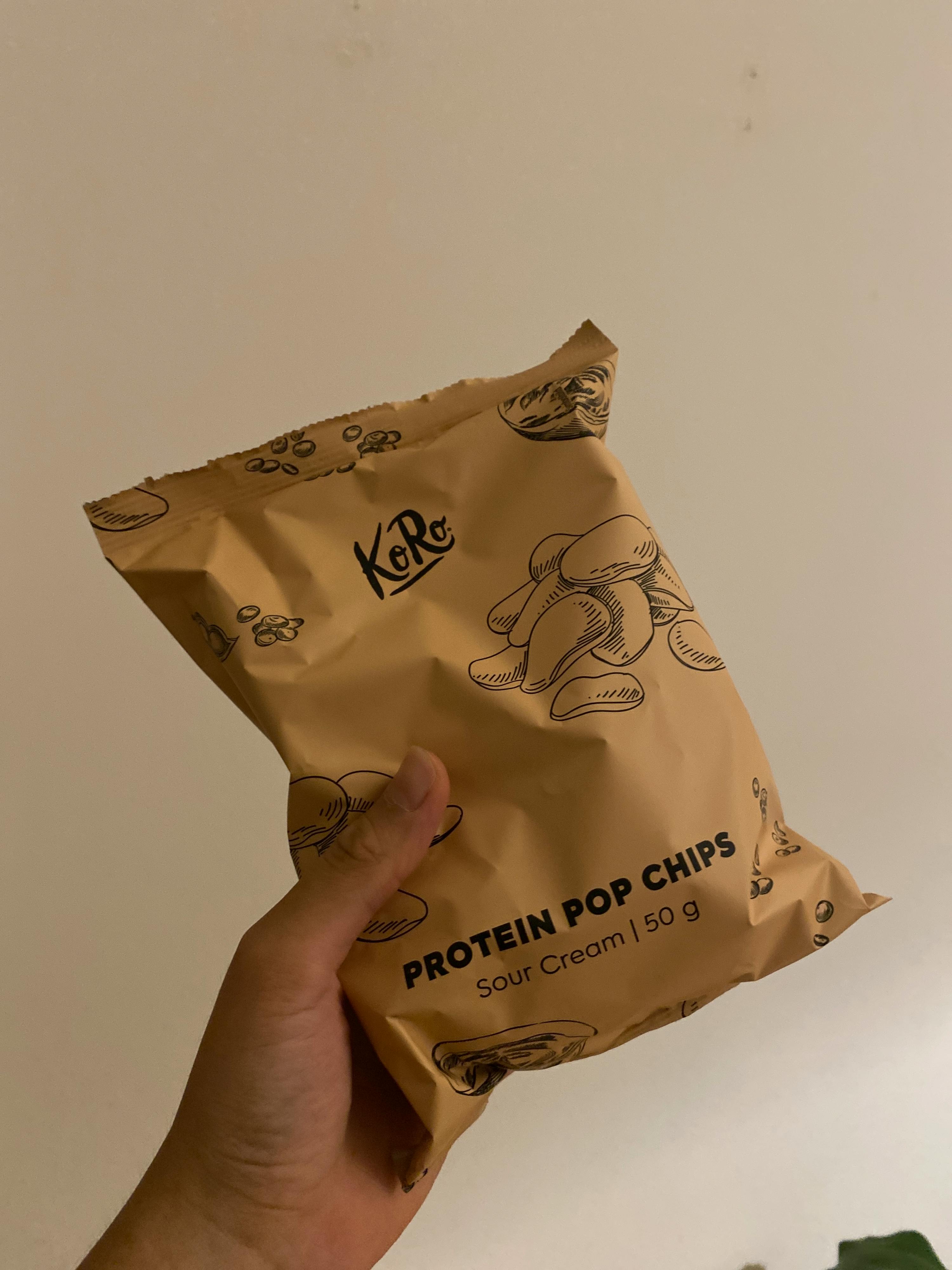 a person holding a bag of protein pop chips