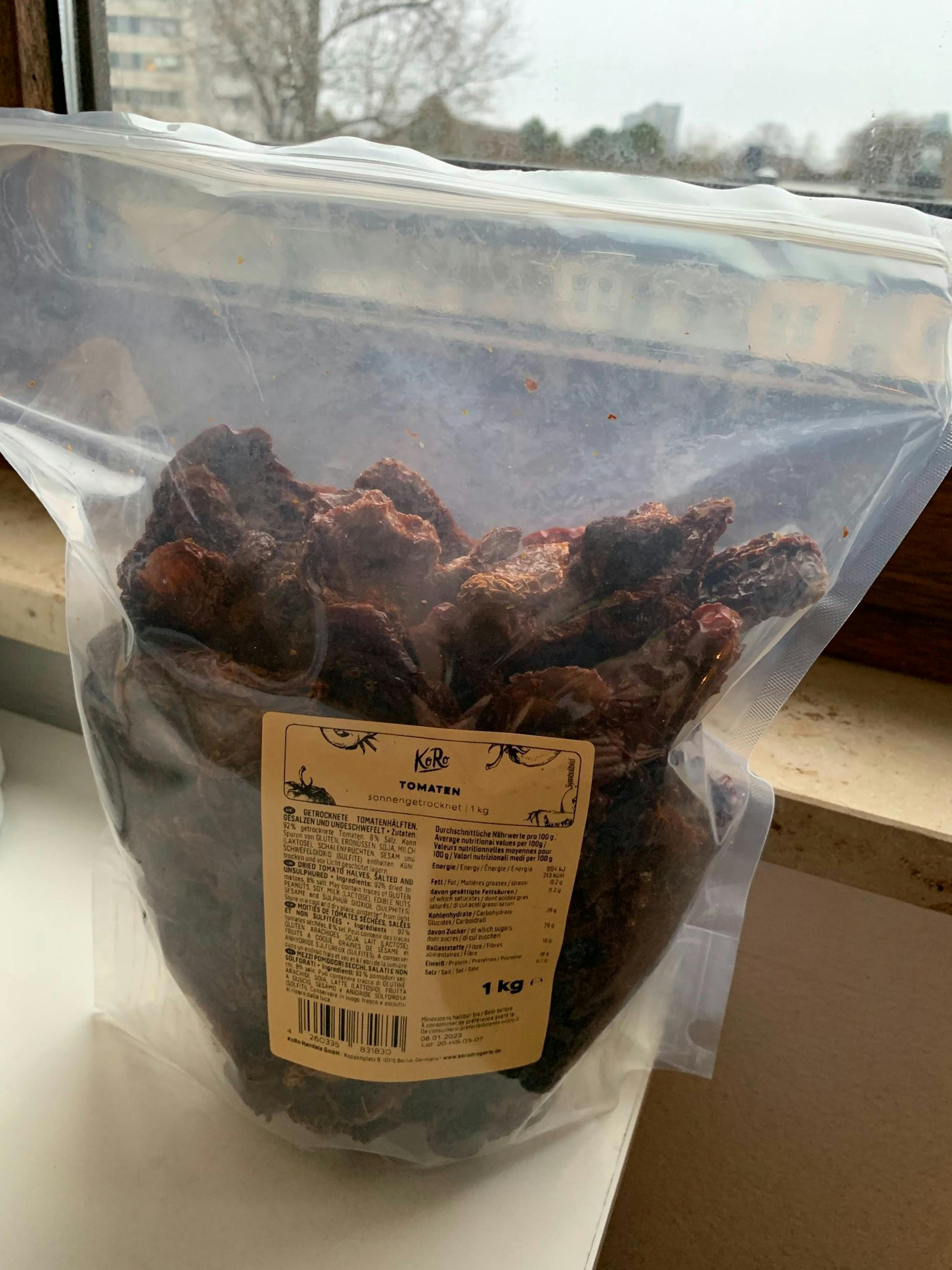 a bag of dried tomatoes from kirb sits on a window sill