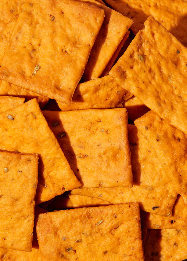 a close up of a pile of orange crackers
