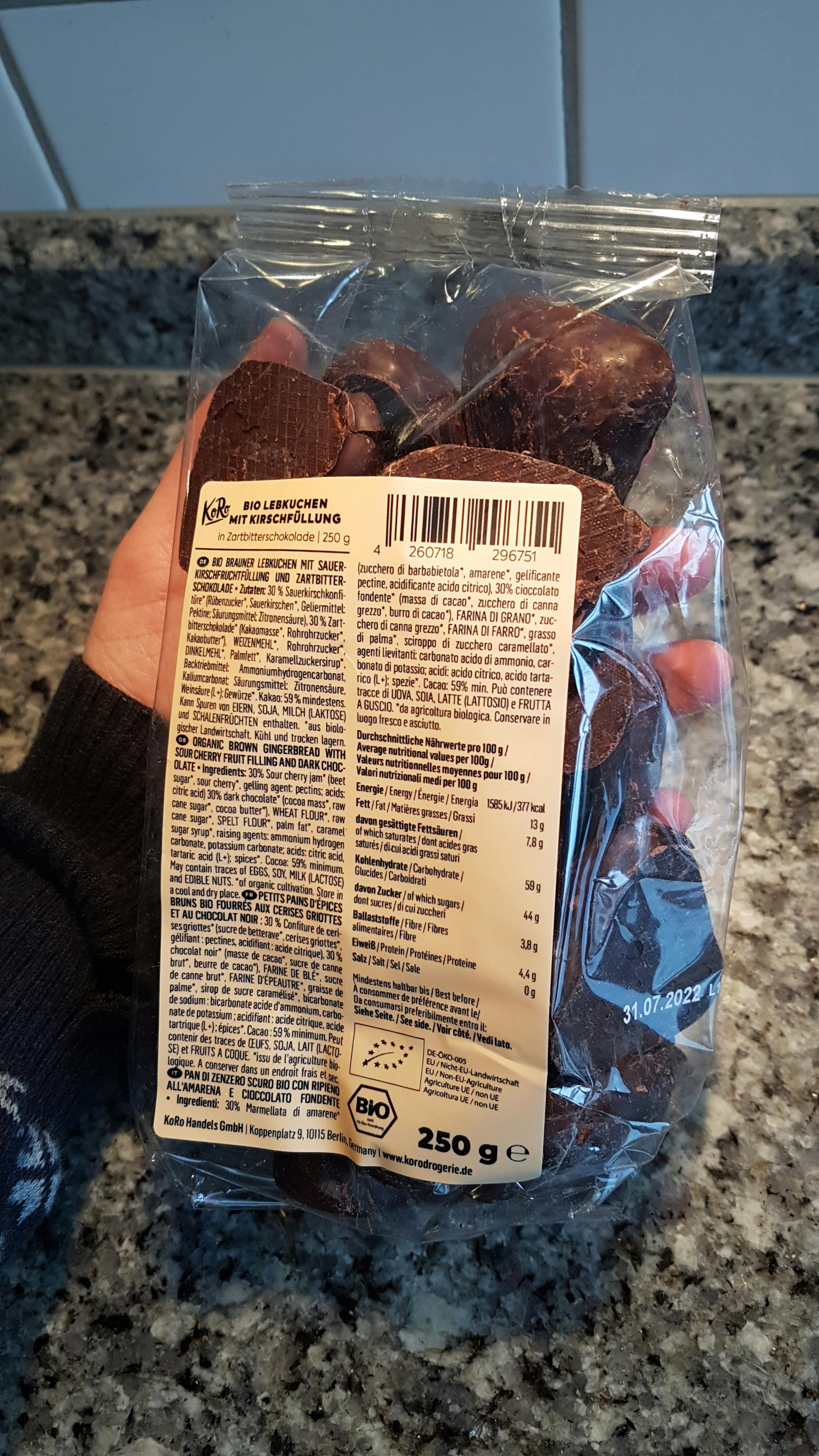 a person is holding a bag of chocolates with a label that says bio