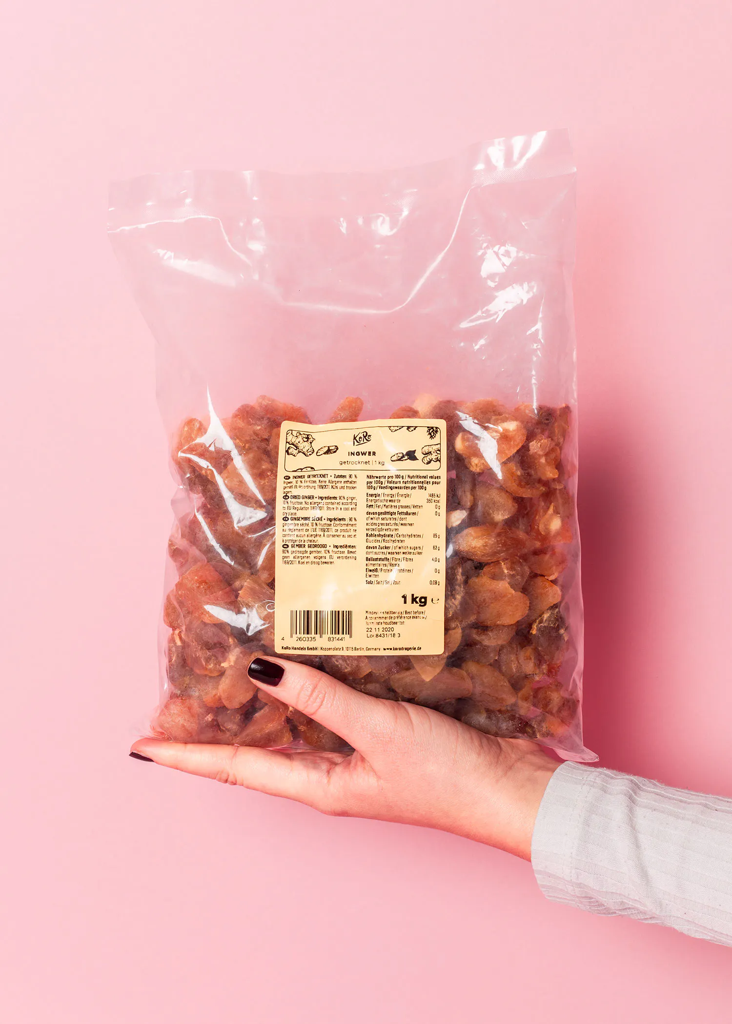 a woman holds a bag of dried apricots in her hand