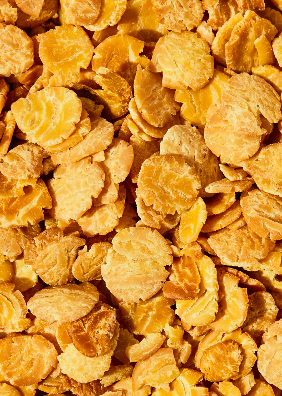 a close up of a pile of corn flakes that looks like pineapples