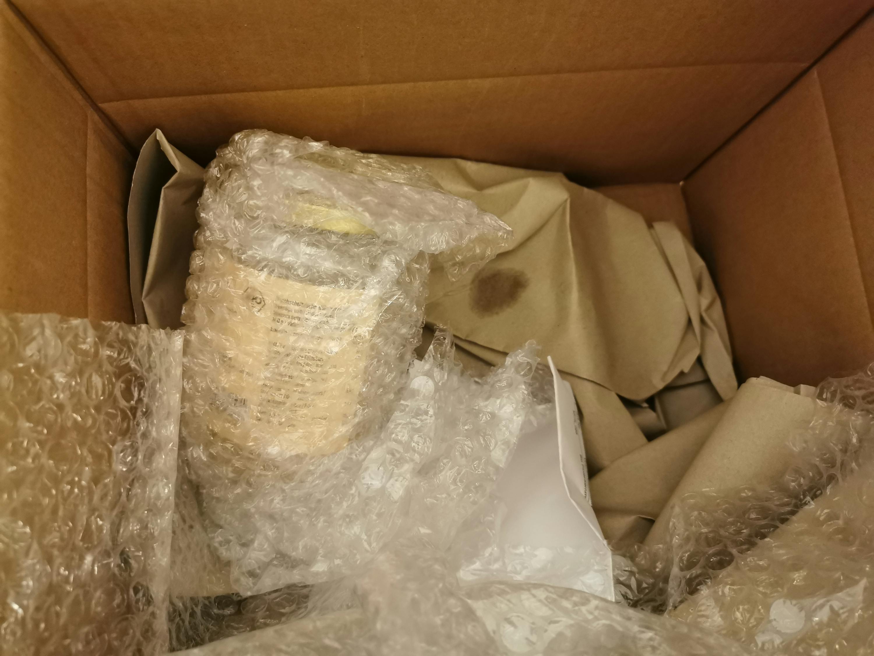 a box with bubble wrap and a bottle in it