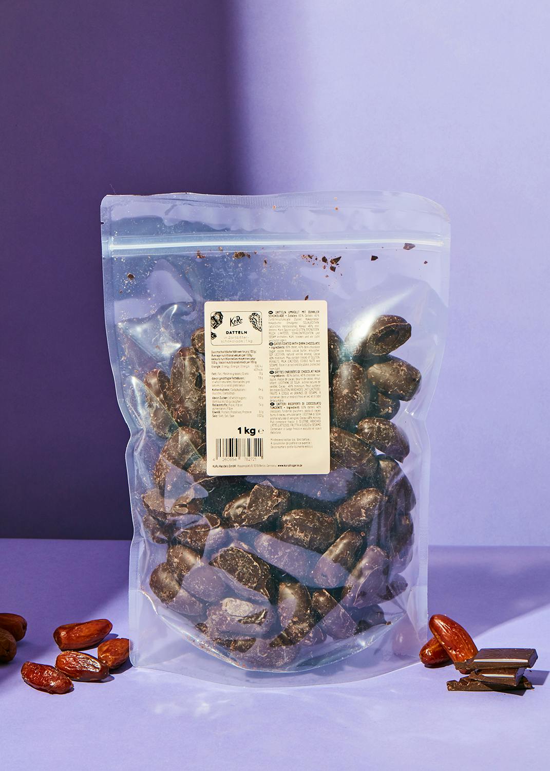 Dates covered in dark chocolate 1kg a bag of chocolate covered dates on a purple table