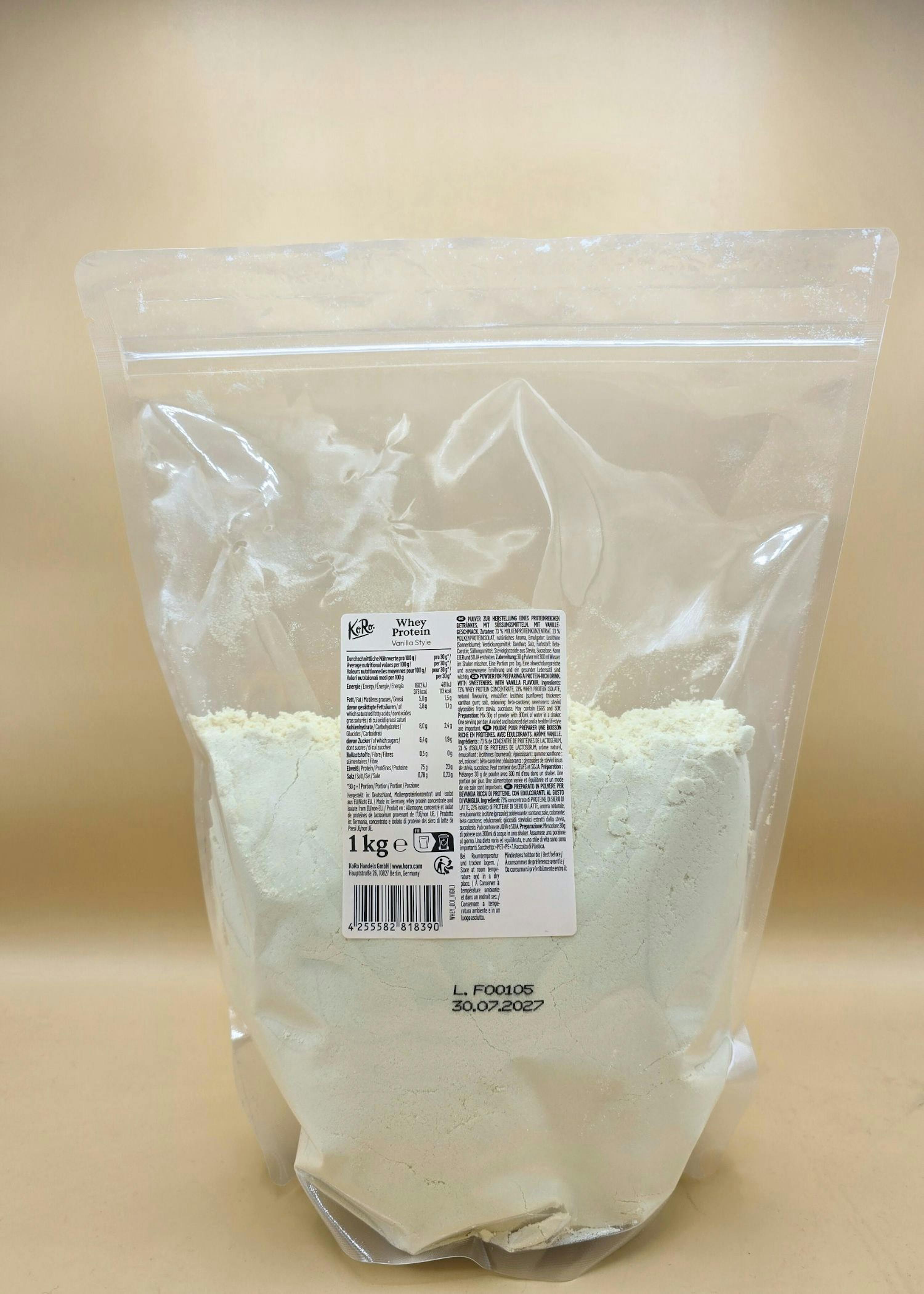 a clear plastic bag of kero vanilla style whey protein powder, weighing 1kg, with nutritional information and an expiration date of 30.07.2027 visible.