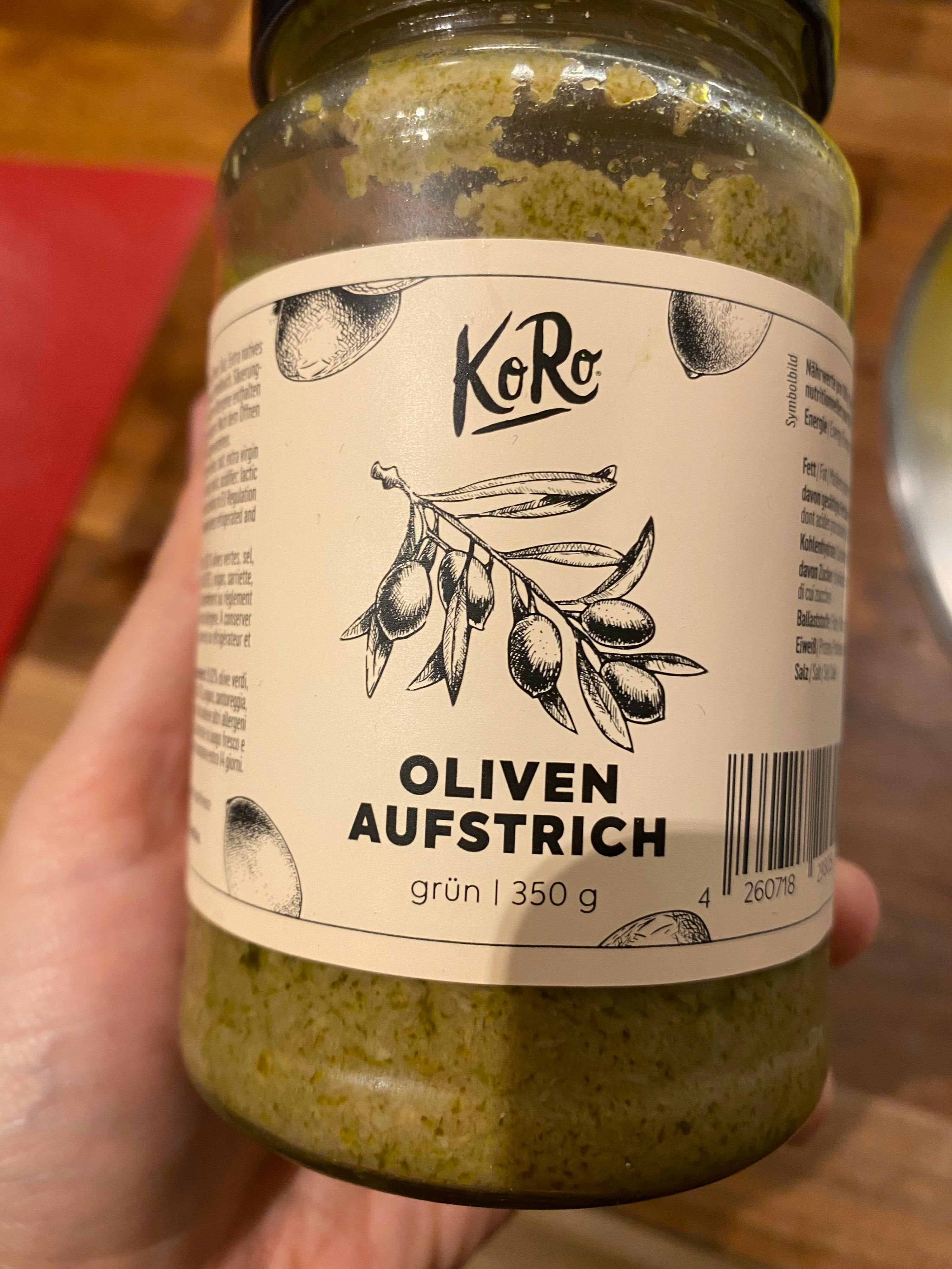 someone is holding a jar of oliven aufstrich