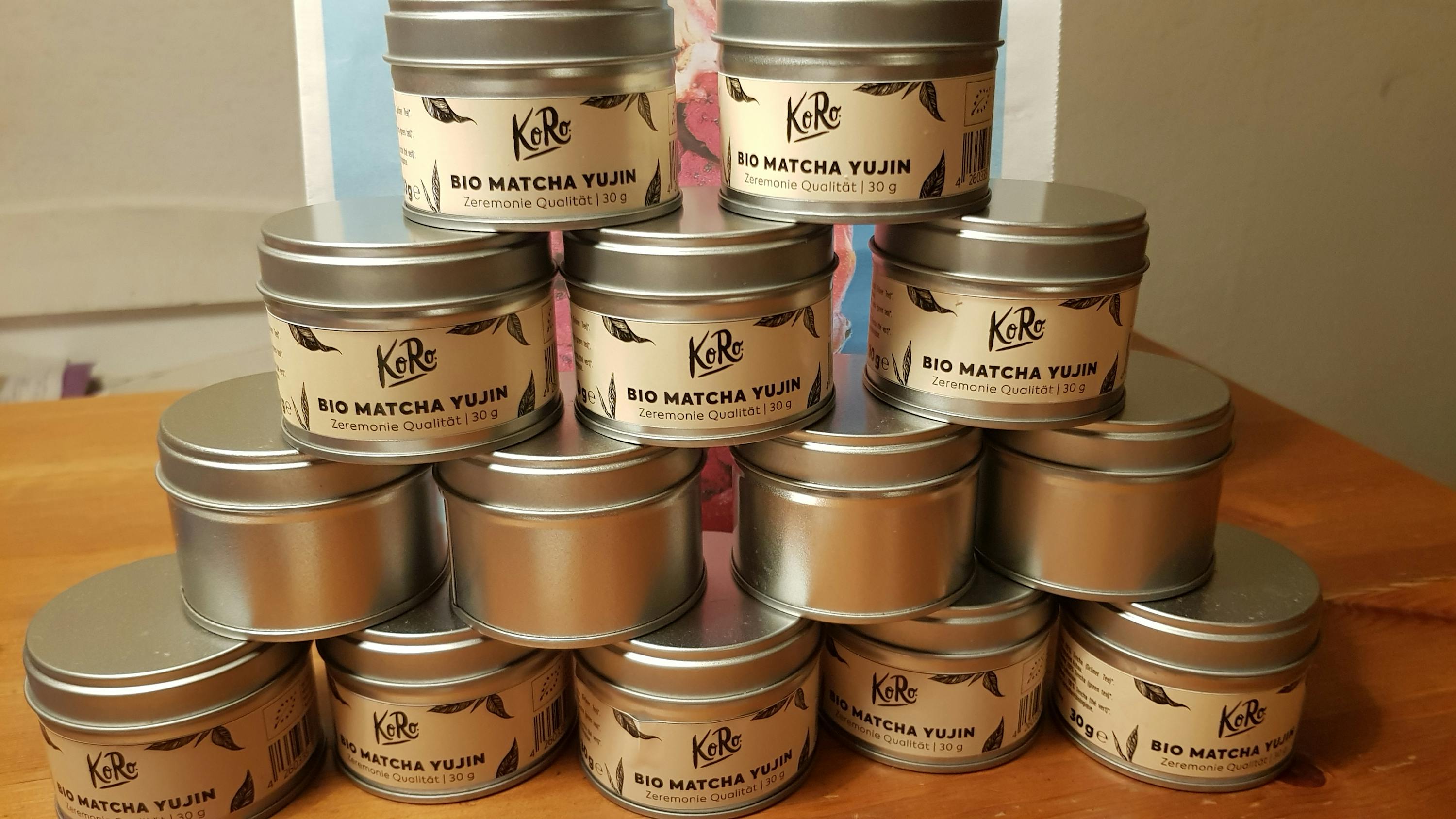 many cans of bio matcha yujin are stacked on top of each other