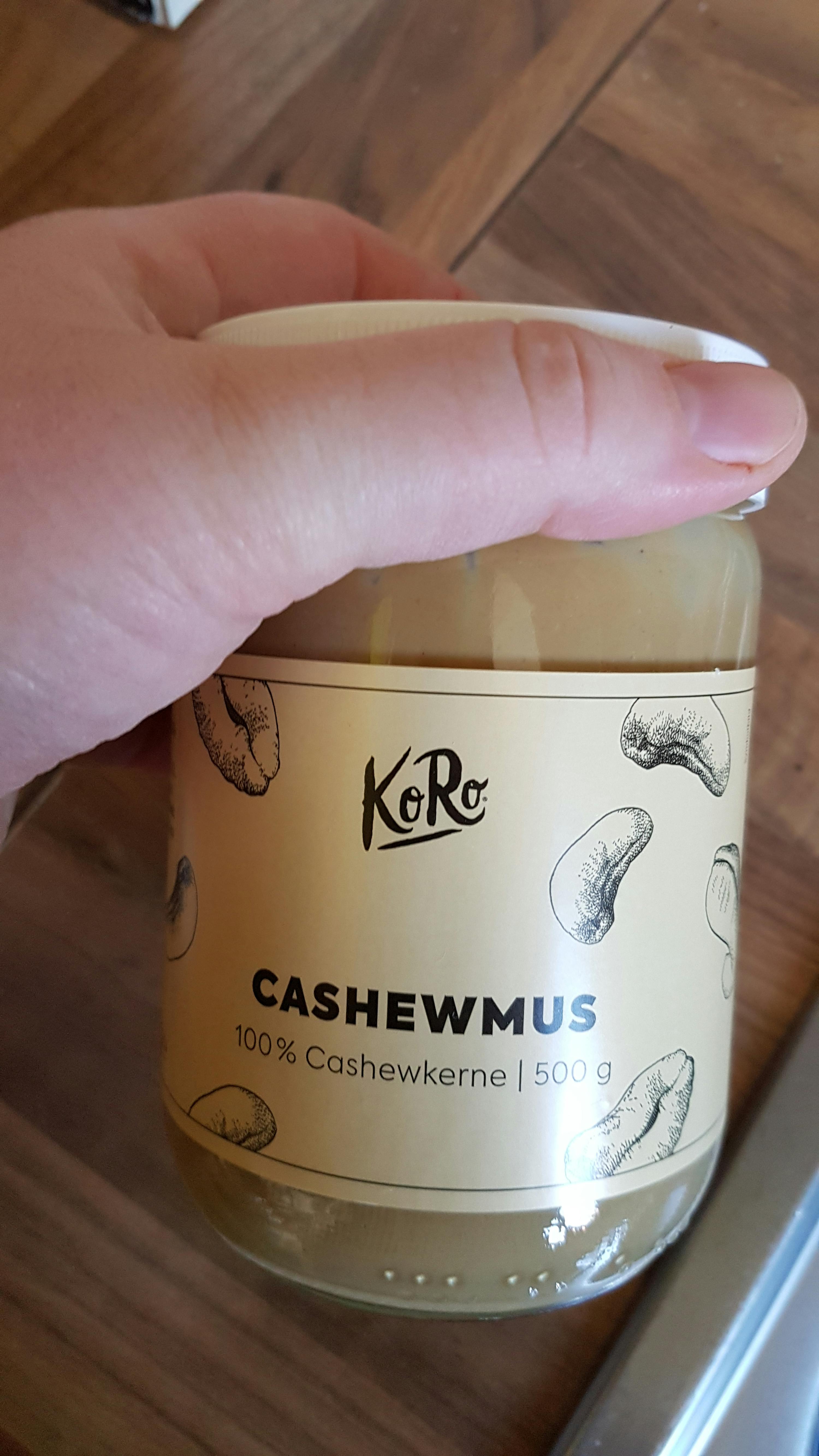 a person is holding a jar of cashewmus