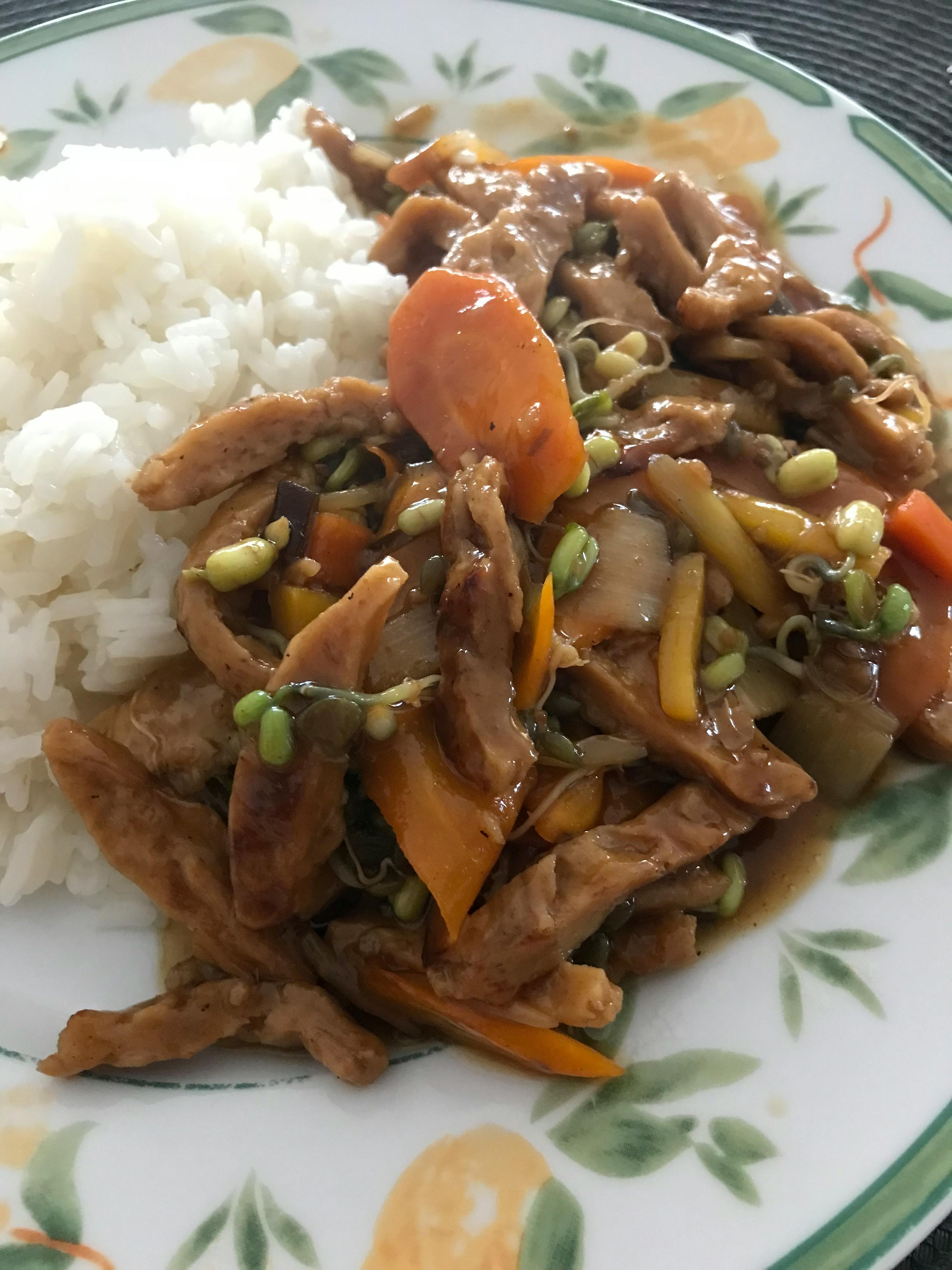a plate of food with rice and vegetables on it